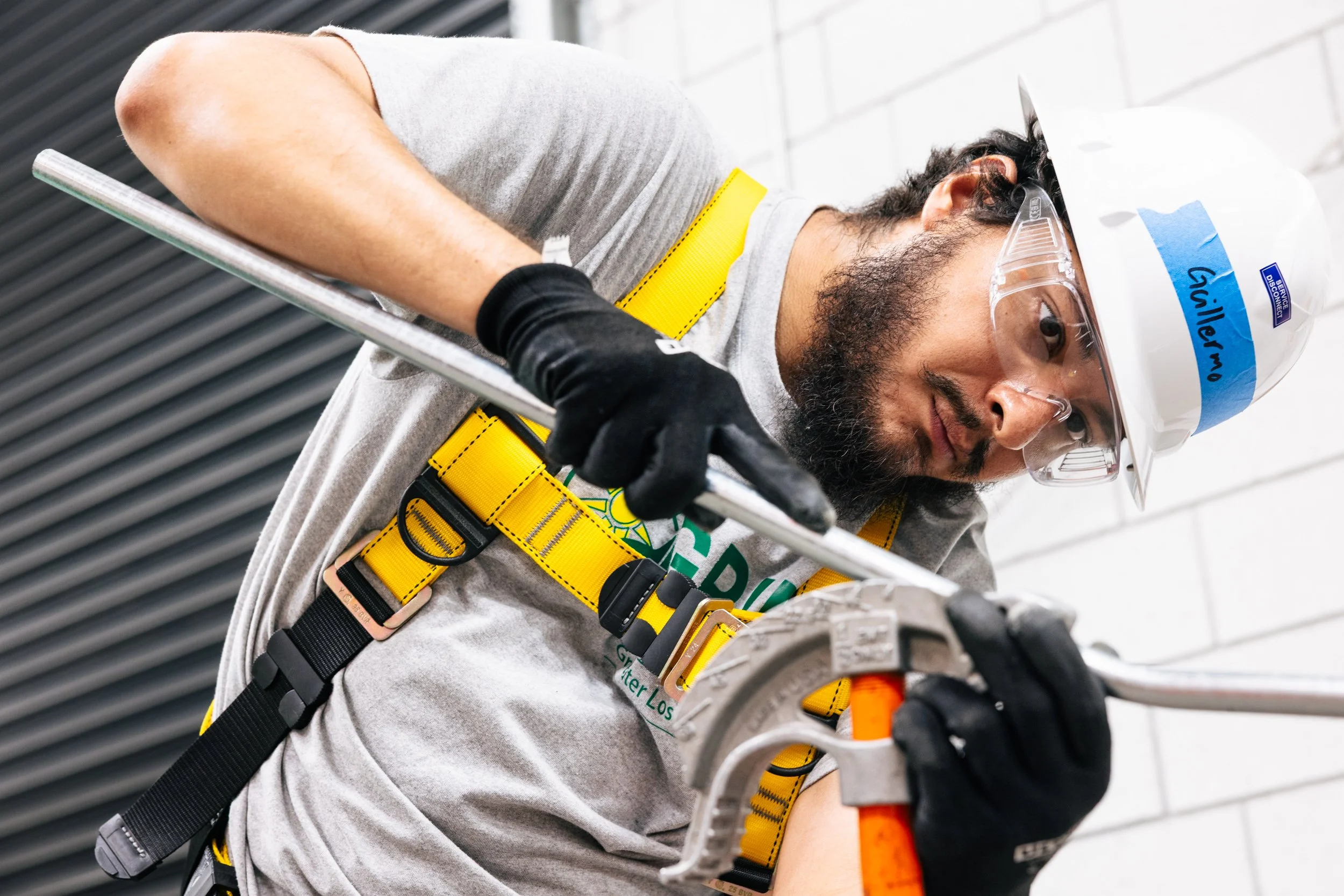 A GRID Alternatives IBT 200 trainee works during solar installation training in Los Angeles, California.
