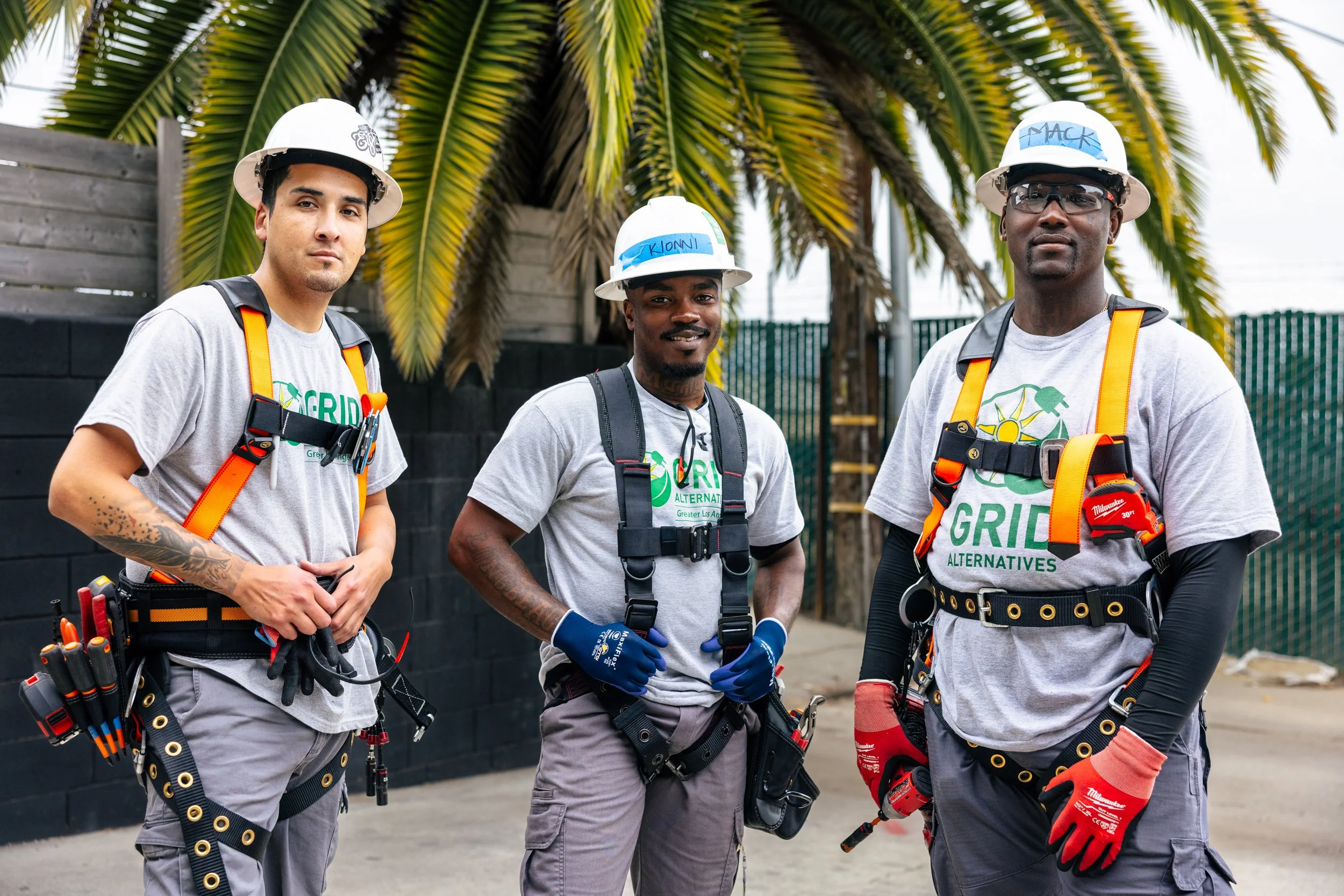 GRID Alternatives IBT 200 solar installation trainees pose in full harness gear at a training site in Los Angeles, California.
