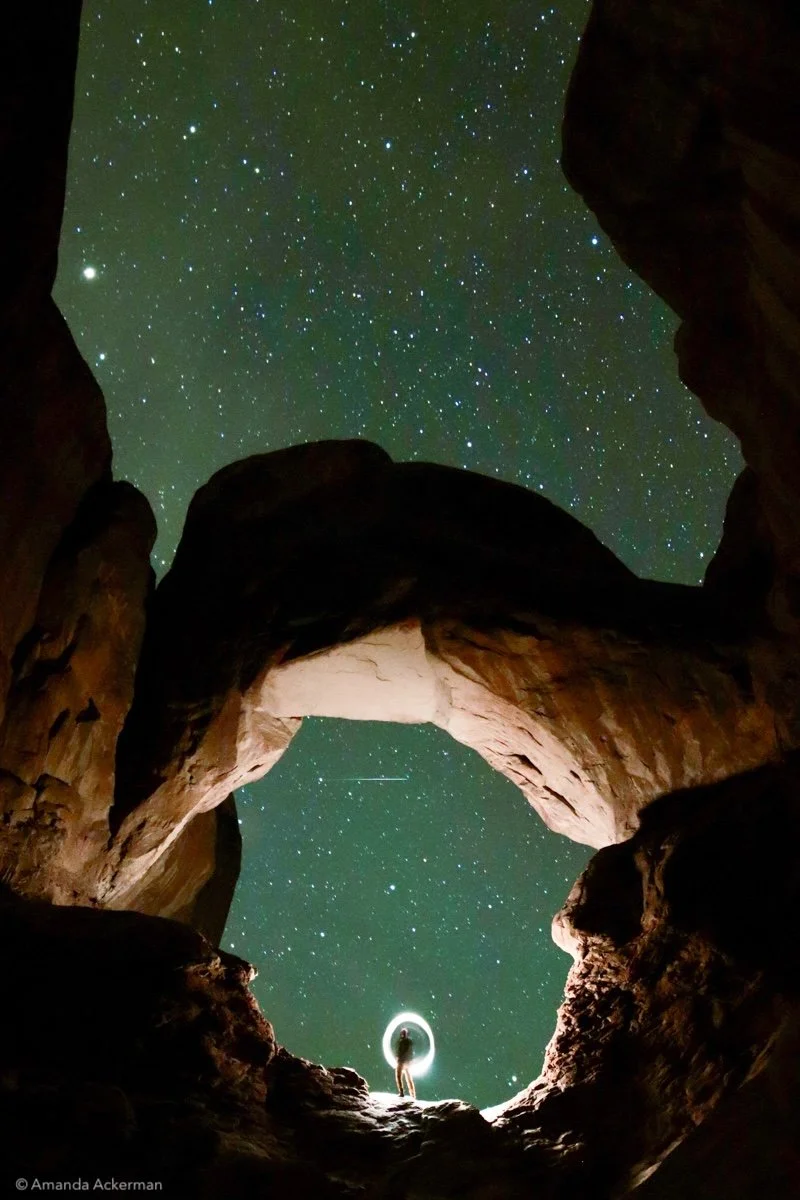 Astrophotography is a forced pause in a world of effortlessly generated images. Waiting in the freezing dark of a remote desert, I sought to capture both a physical and emotional threshold. A massive geological arch frames the deep cosmos, while a li