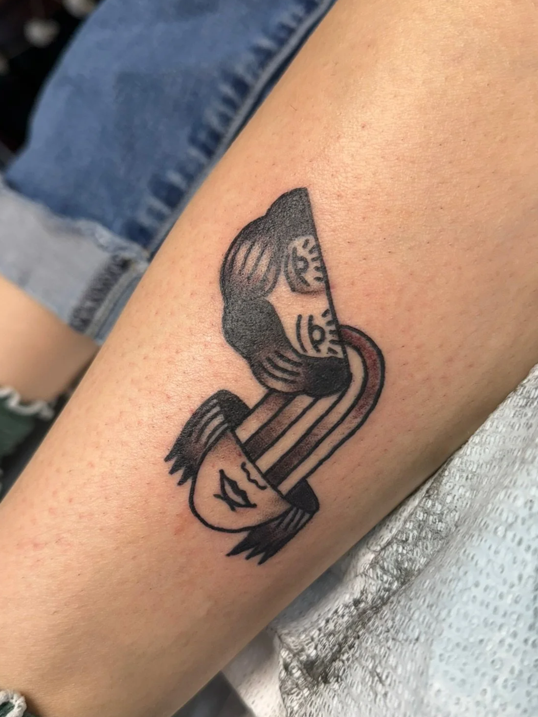 Surrealist tattoo of a lady face in black and gray ink by Leah Fries, located at Moth to a Flame Tattoo, Old Colorado City