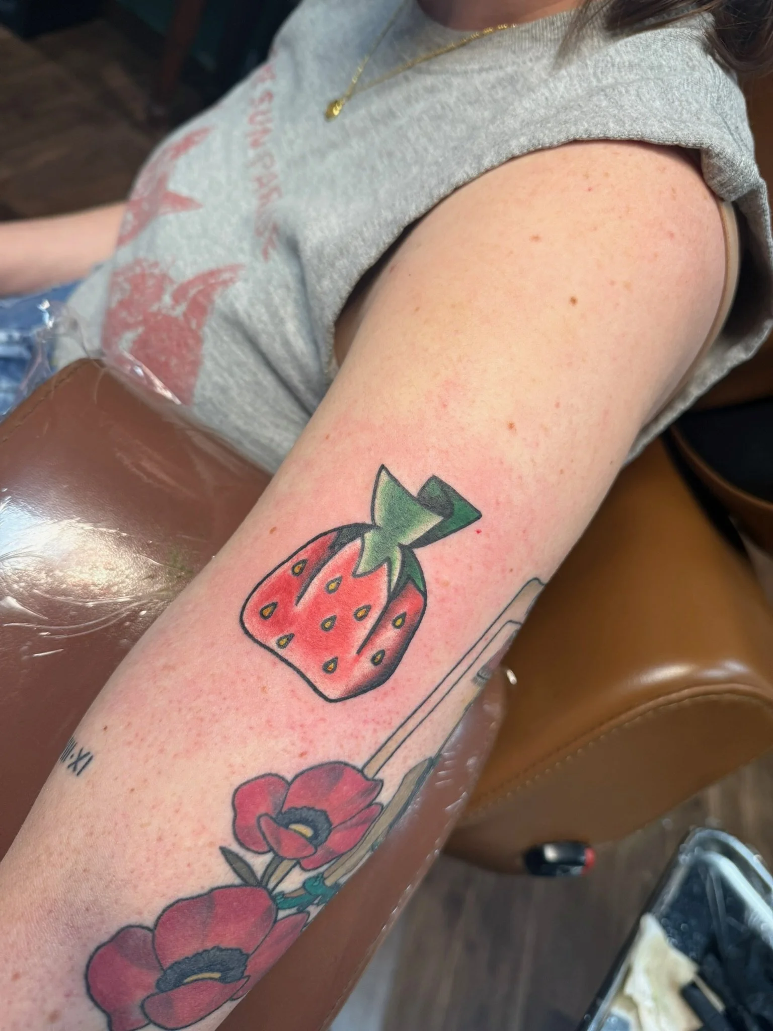 Wrapped strawberry candy tattoo by Leah Fries located at Moth to a Flame Tattoo Old Colorado City