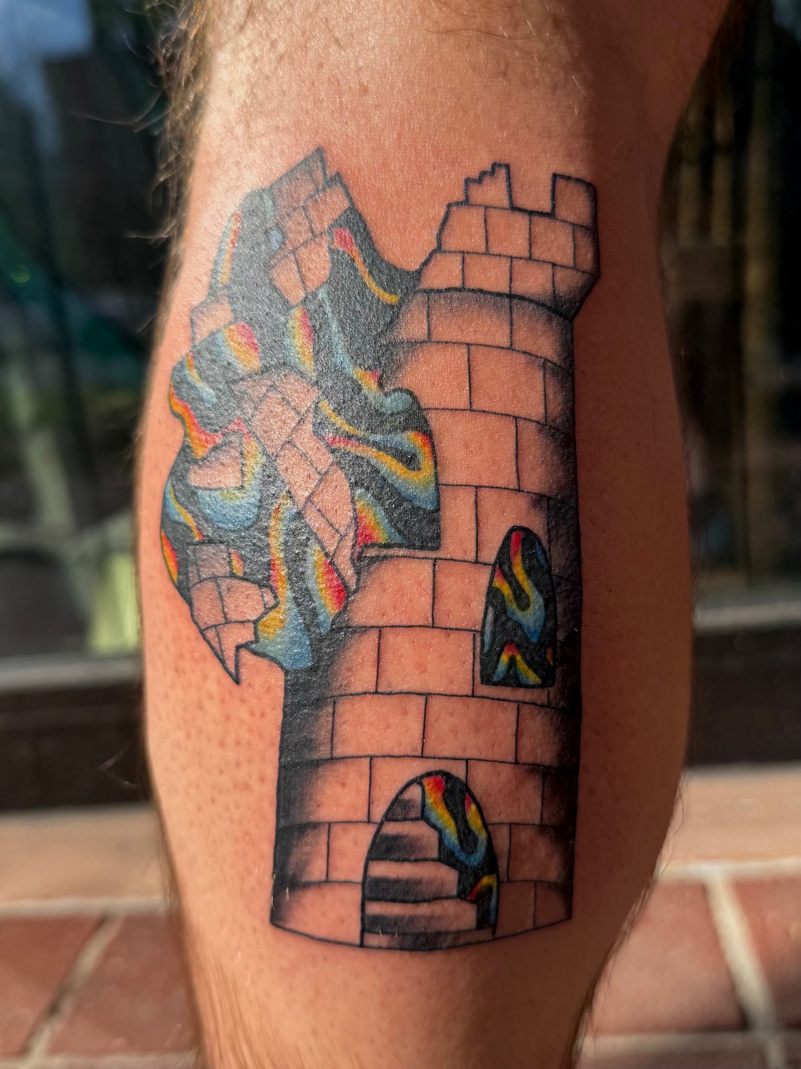 Surrealist castle tattoo in full color ink by Leah Fries located at Moth to a Flame Tattoo Colorado Springs