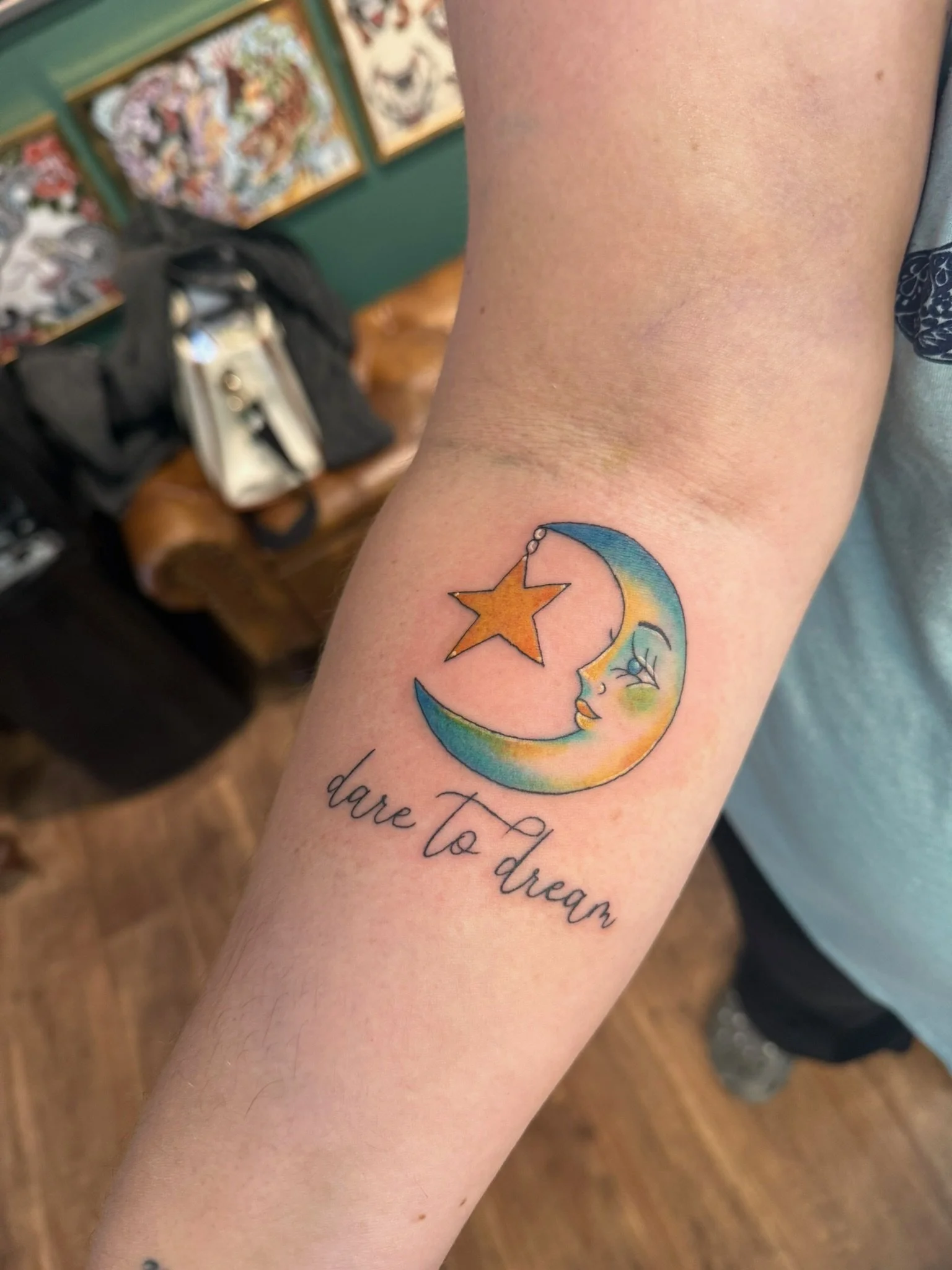 Pretty crescent moon tattoo in full color ink by Leah Fries located at Moth to a Flame Tattoo Colorado Springs