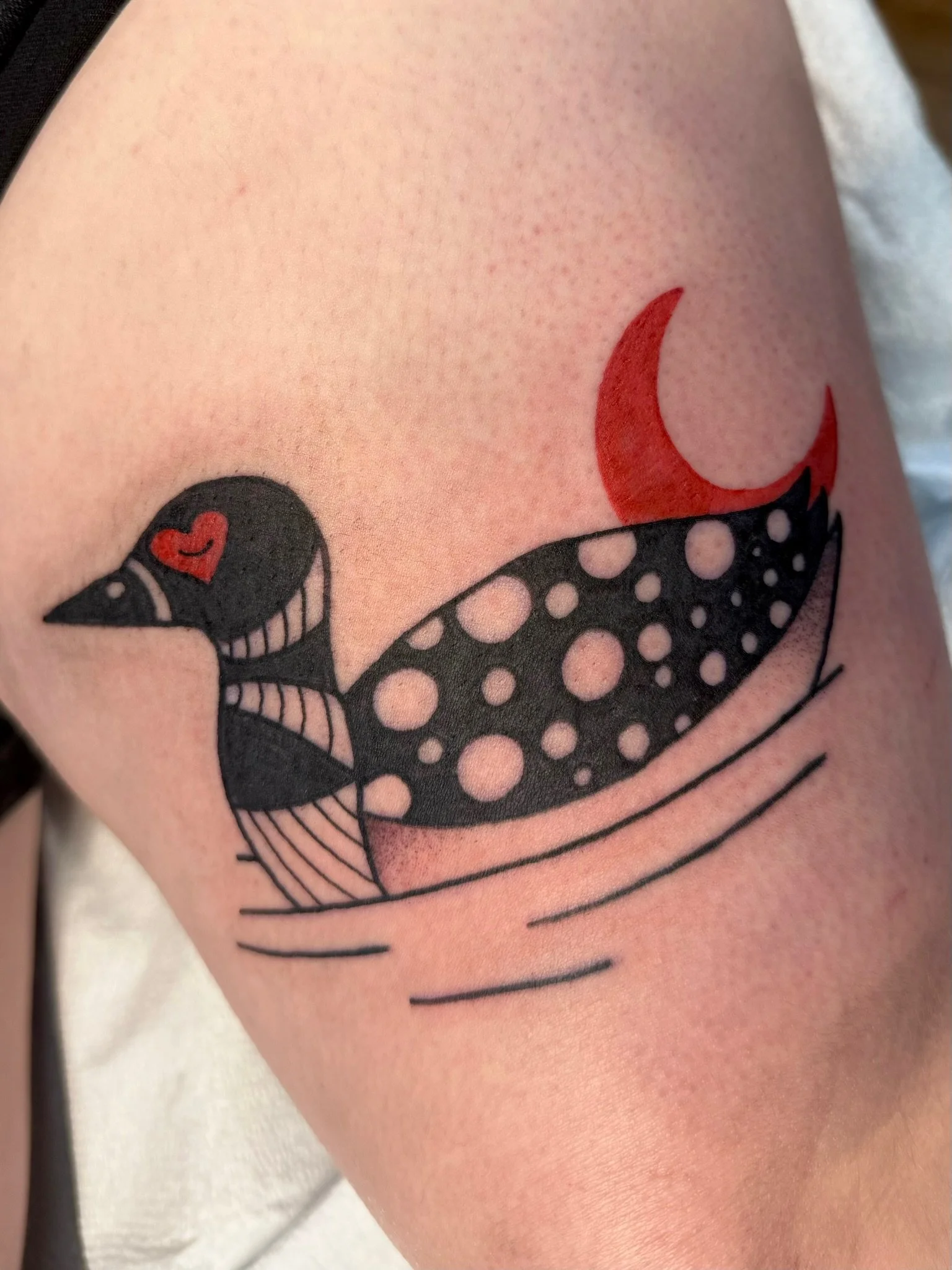 A loon bird tattoo in full color ink by Leah Fries located at Moth to a Flame Tattoo Colorado Springs