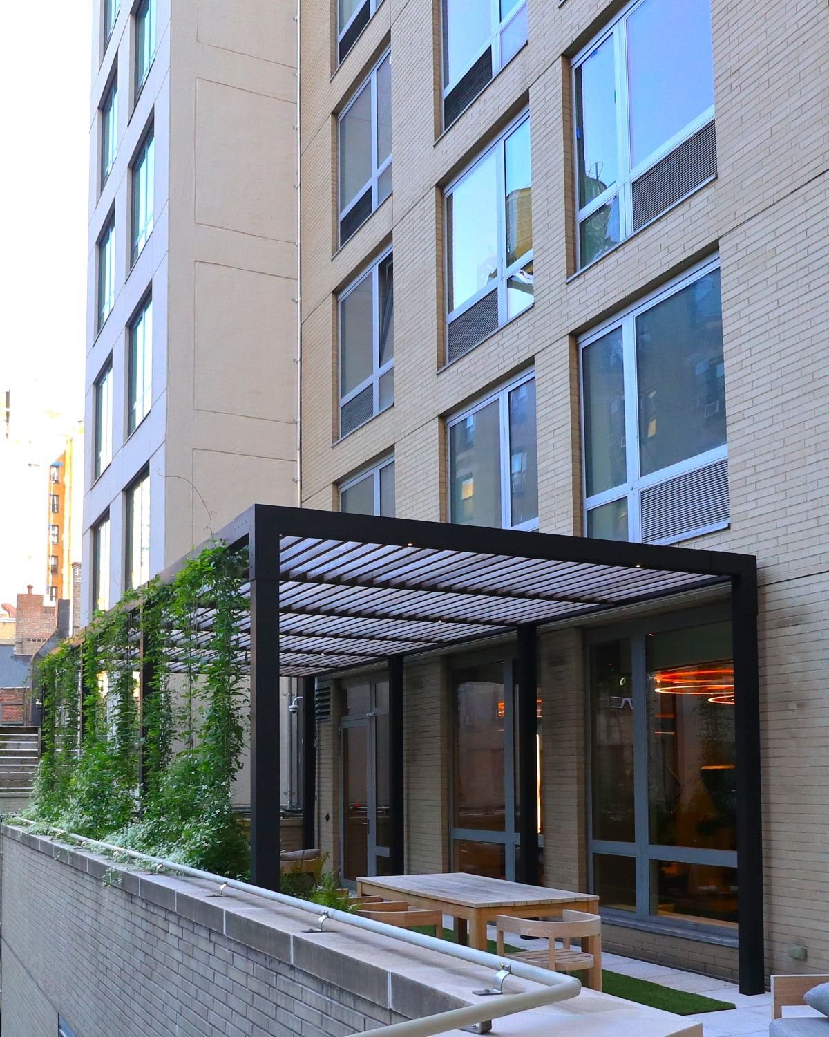 Shade pergola with climbing vines and outdoor lounge amenity space - landscape design