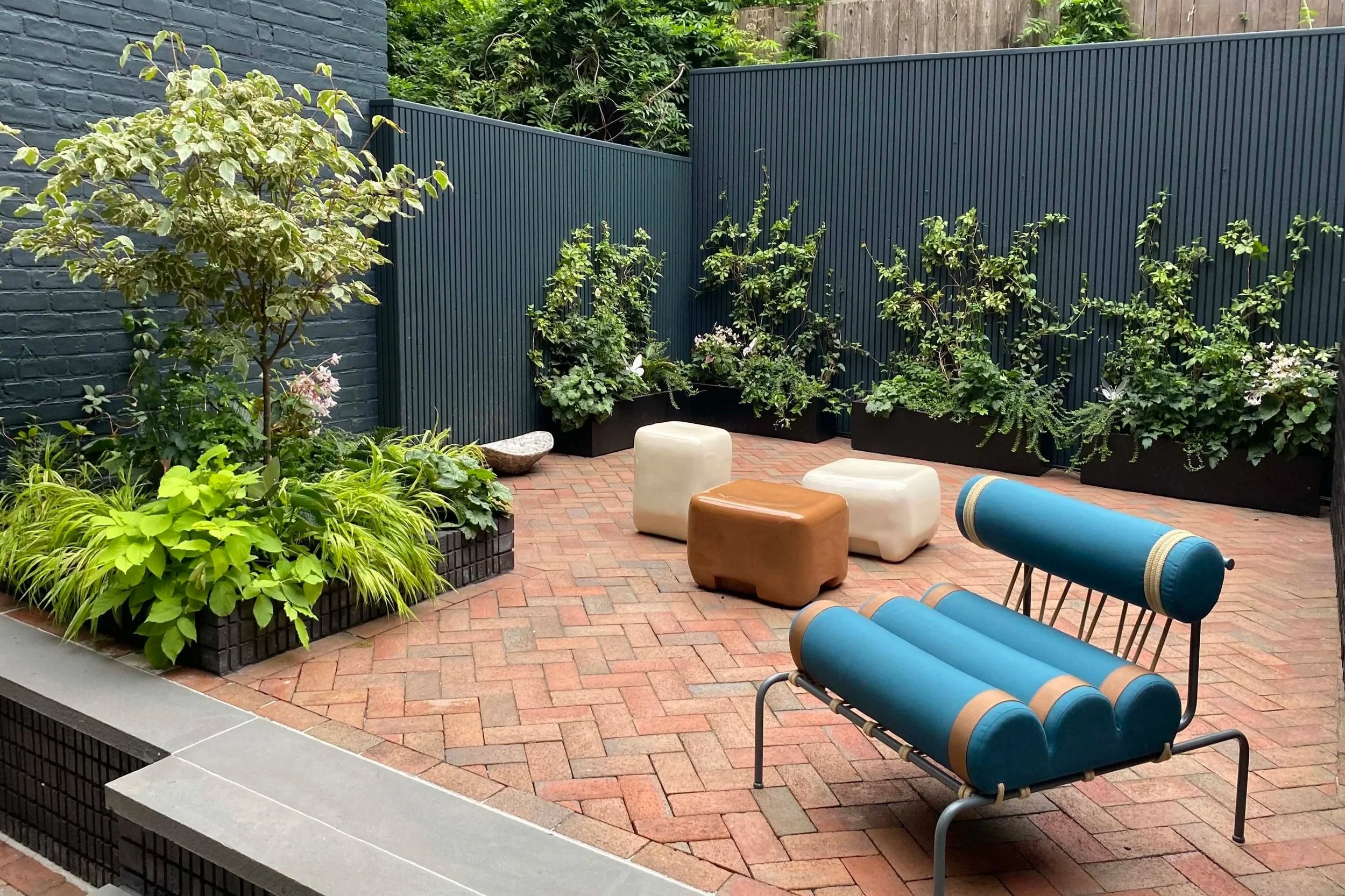 Brick and bluestone patio planting dogwood cedar fence Soho NYC Backyard Landscape Design