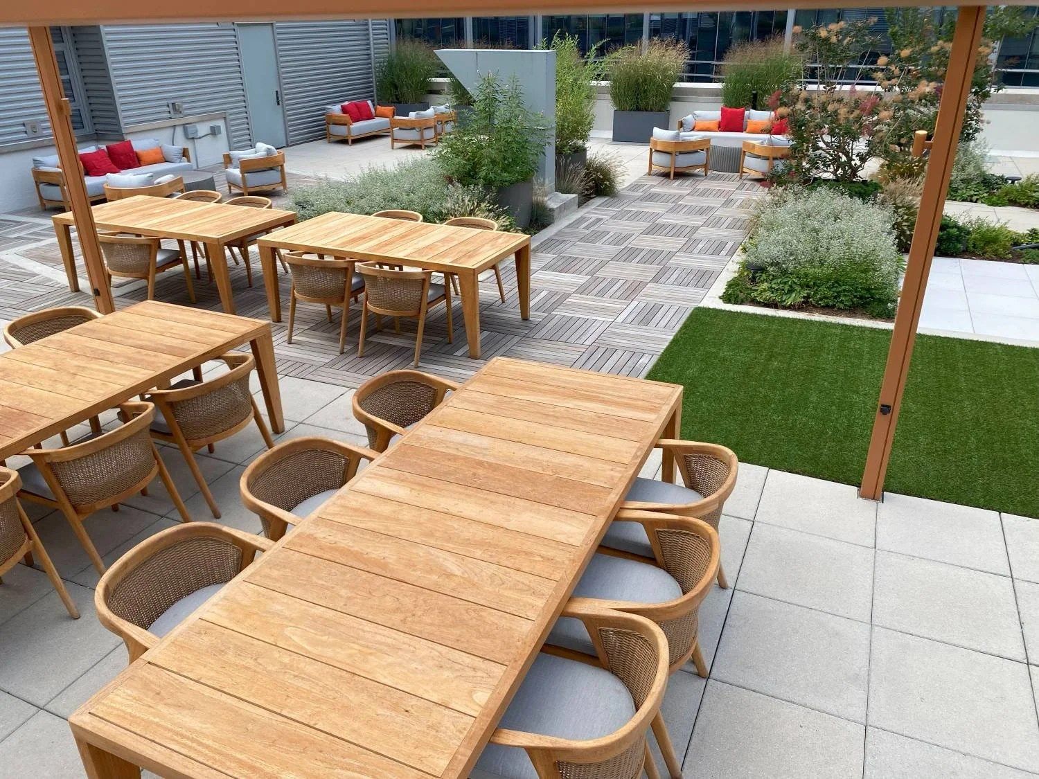 Outdoor dining on private amenity rooftop with modern wood furniture