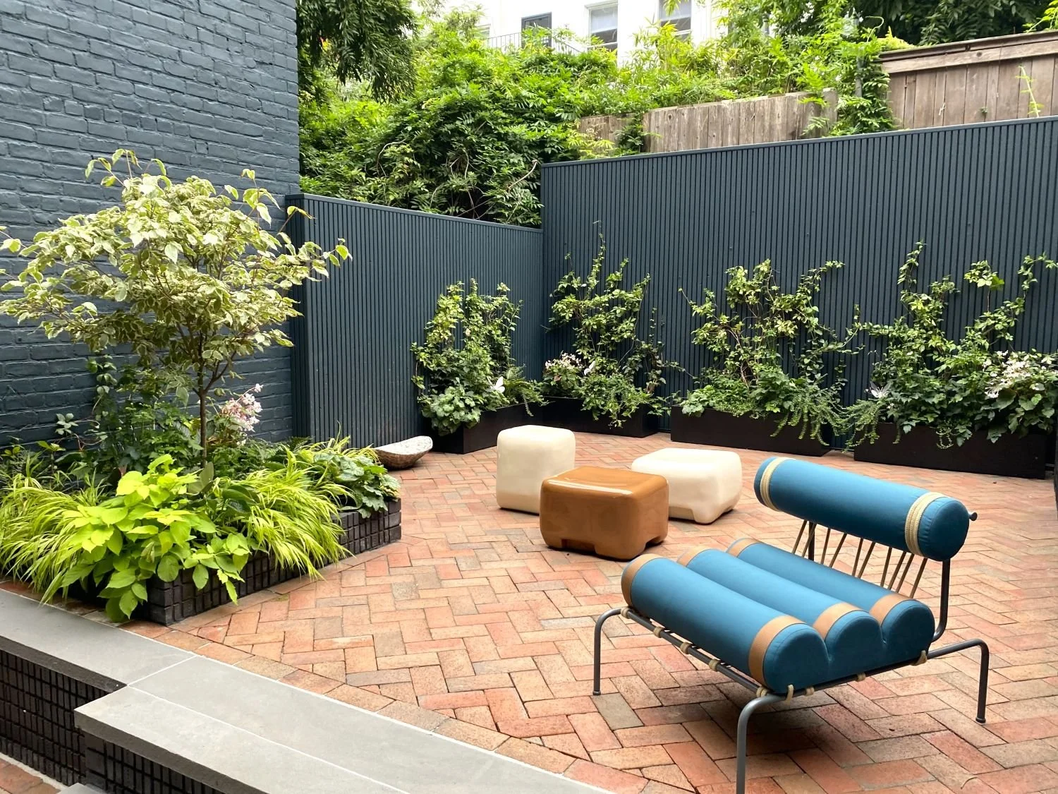 Modern backyard landscape design with brick patio