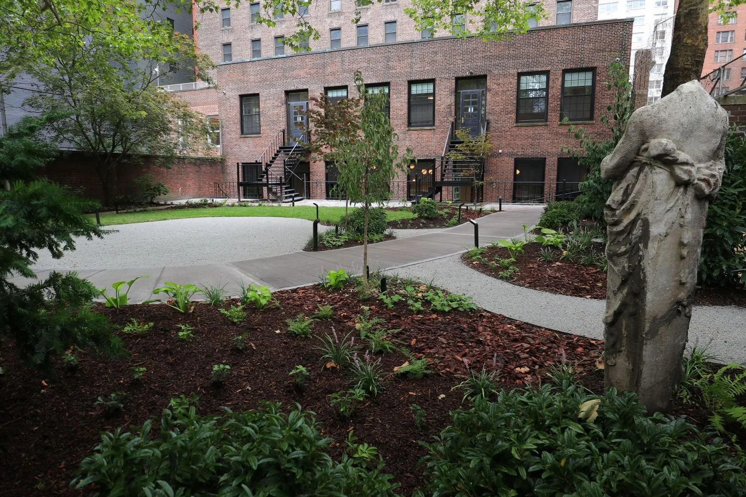 Traditional and modern landscape design elements and forms. Brick and gravel patio