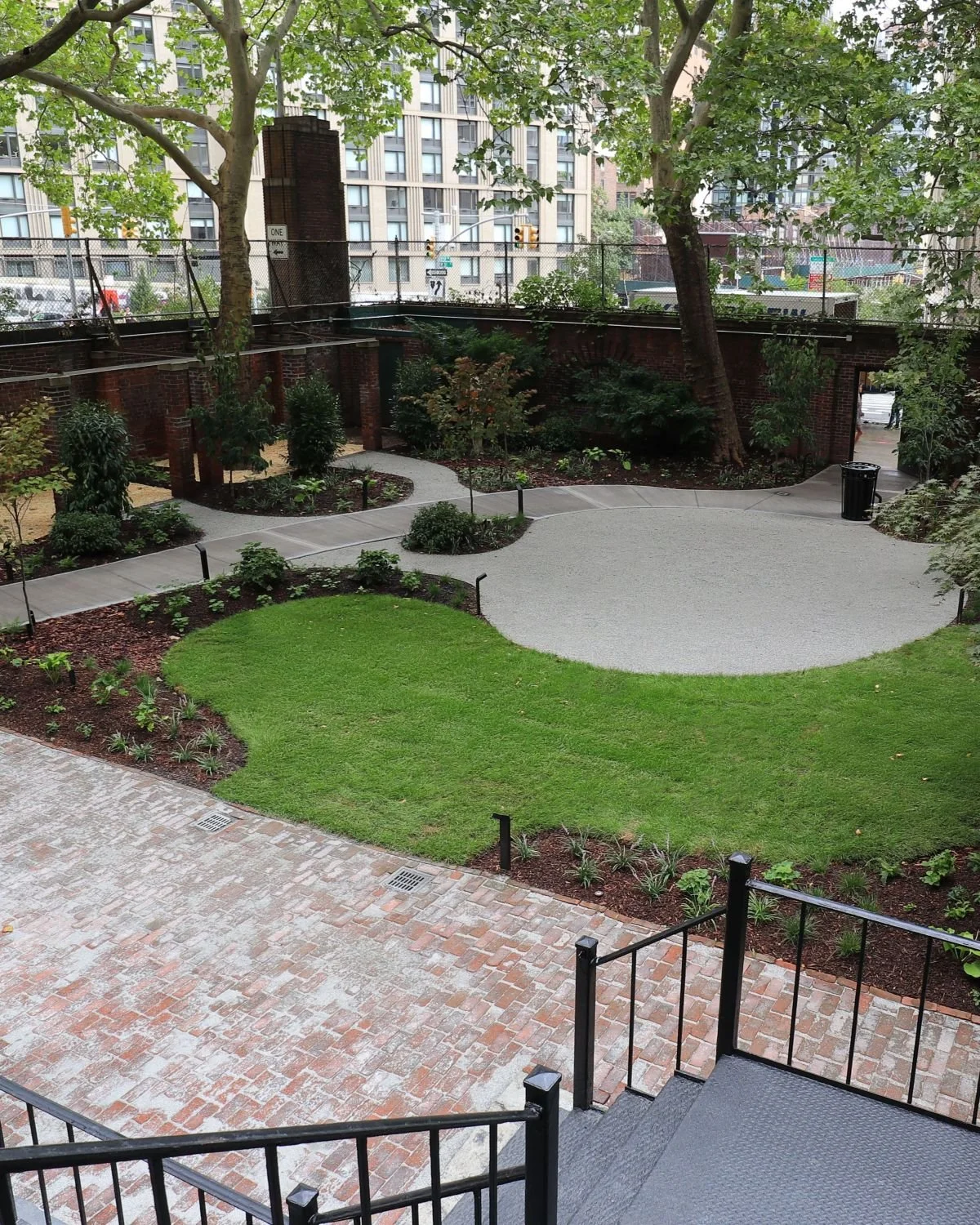 A mix of traditional and modern landscape design elements and forms. Brick and gravel patio