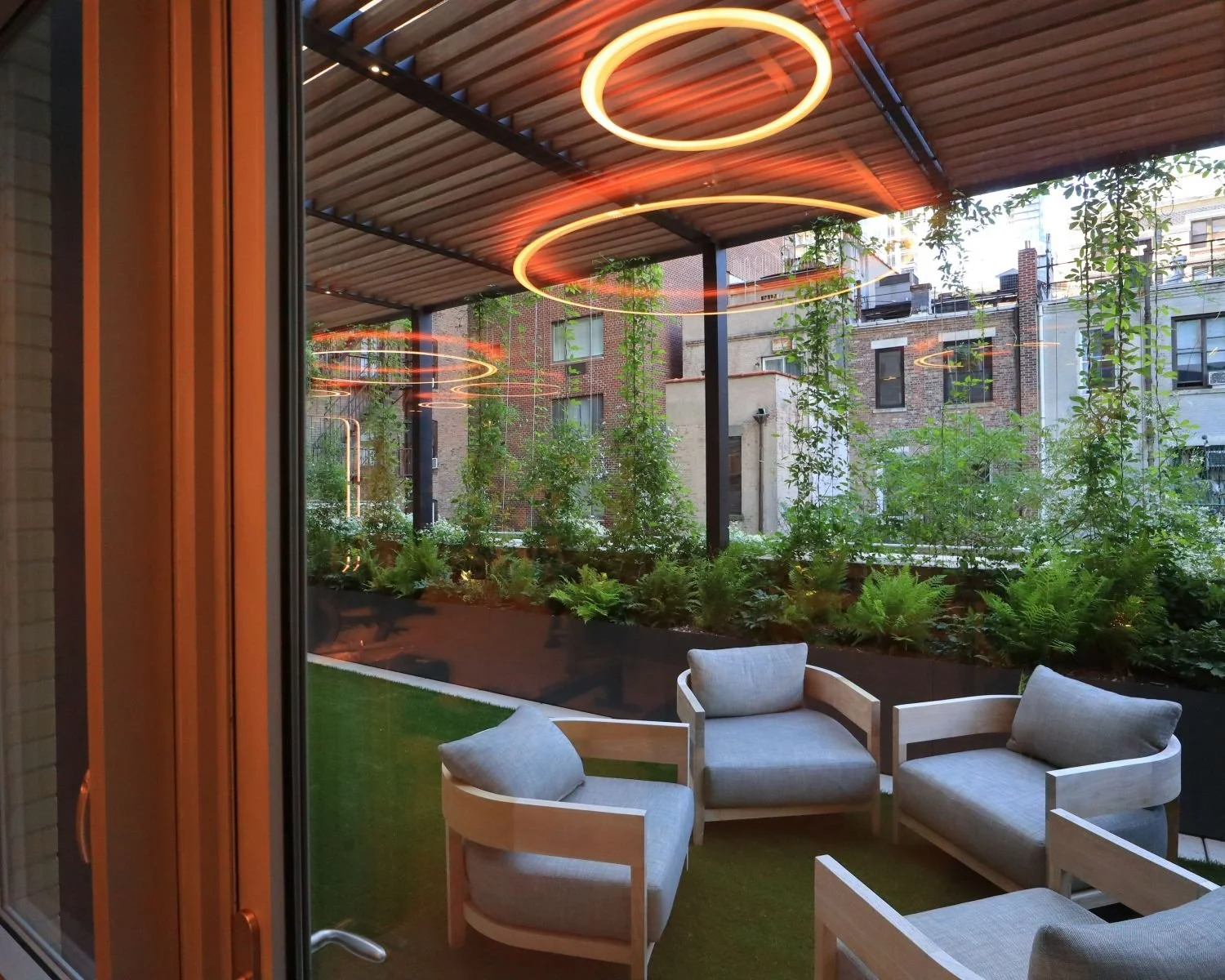 Shade pergola with climbing vines and outdoor lounge amenity space