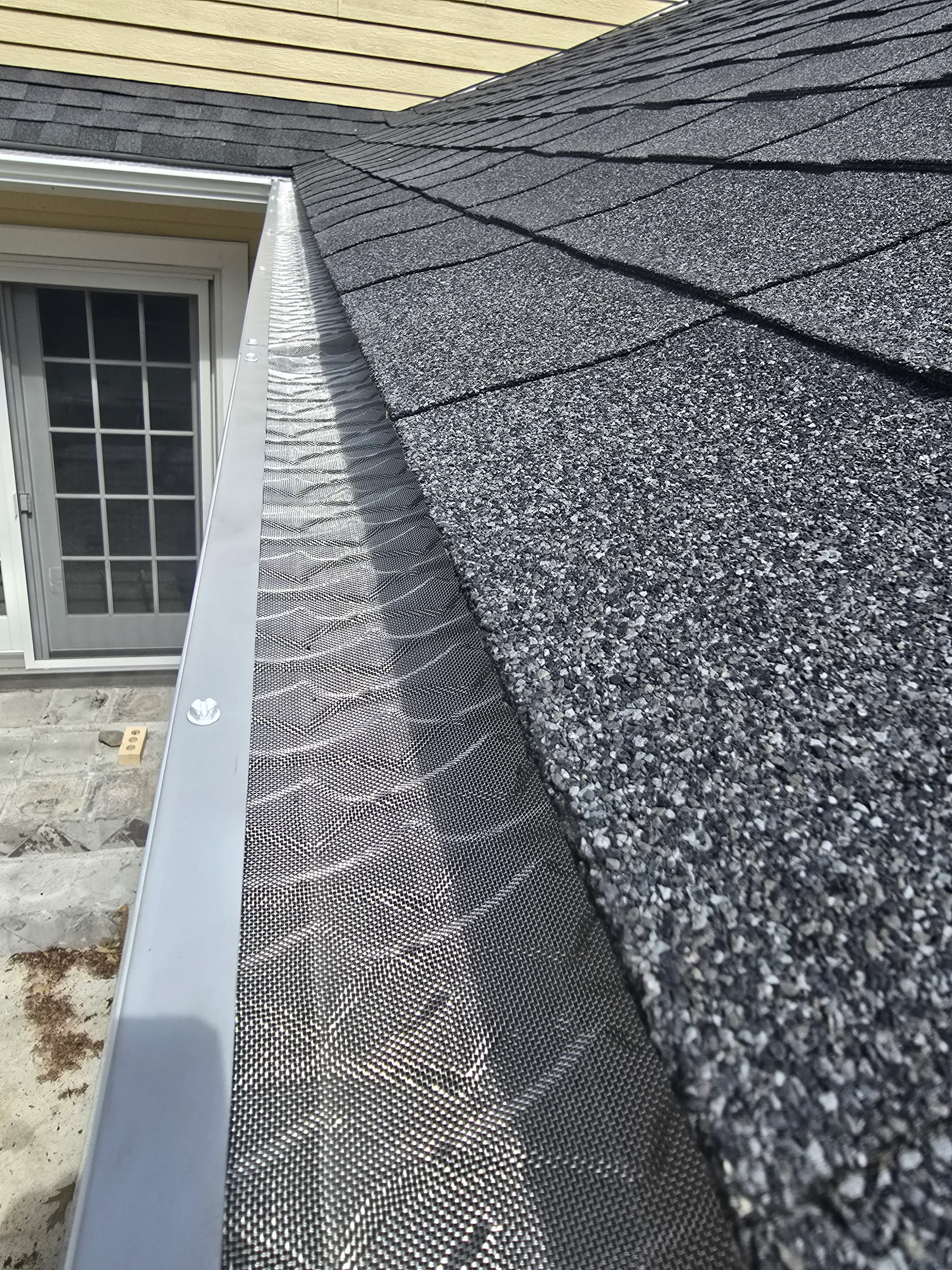 365ft of white 5-inch .032-gauge aluminum seamless gutters with hidden hangers, micro-mesh gutter screening, 2x3 downspouts, and (14) miters in Shrewsbury, MA | Royalty Gutters LLC