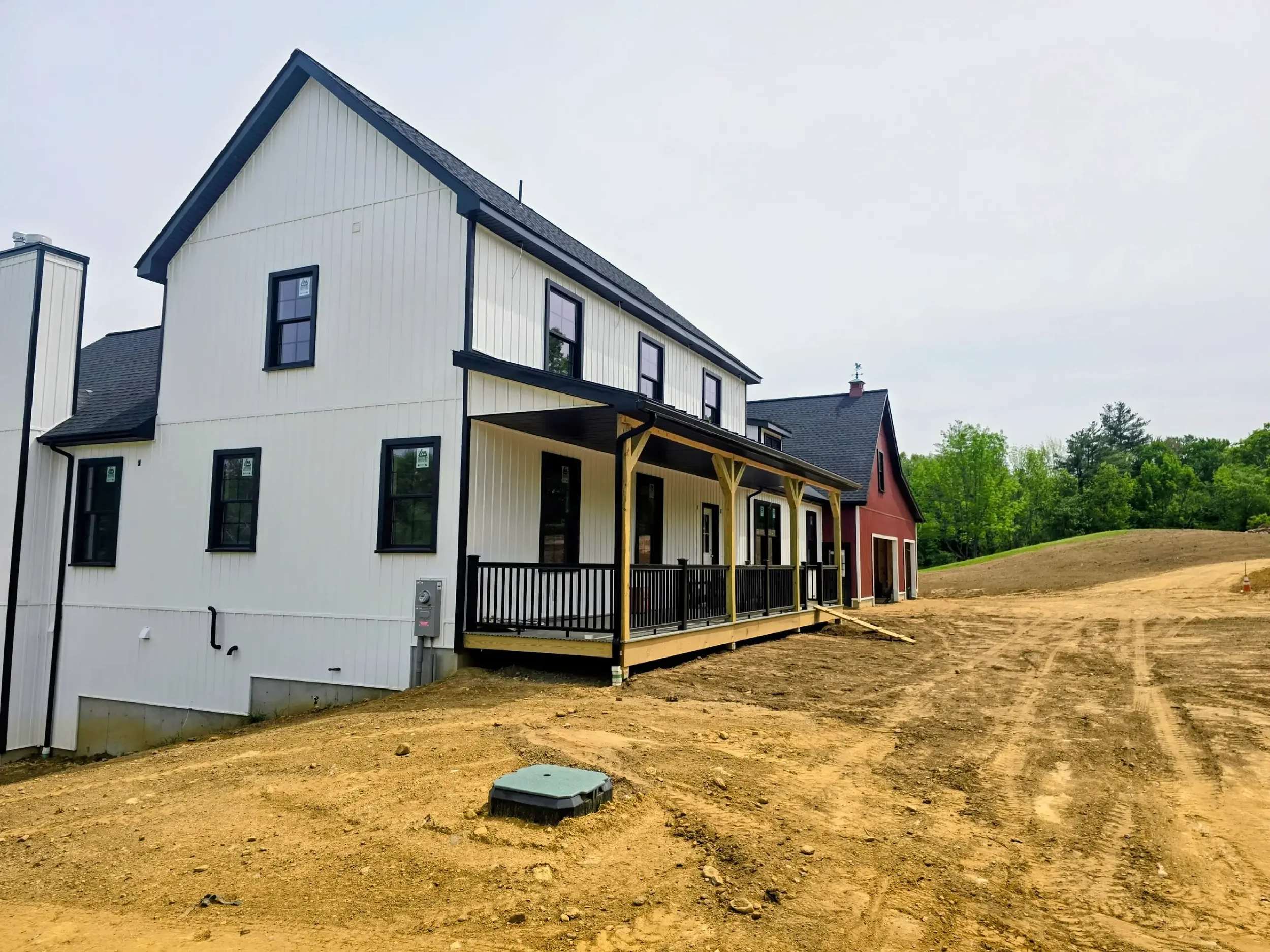  5" black .032-gauge aluminum seamless gutters Hidden hangers for superior strength and a clean finish Black 2x3 downspouts 2 custom inside miters in North Brookfield, MA Royalty Gutters LLC 2026
