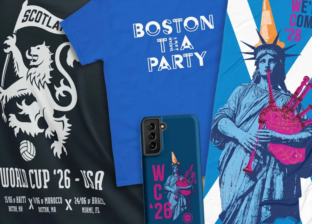 Collection of sports memorabilia and merchandise for the 2026 FIFA World Cup in the USA, featuring a Black and white scarf with a lion and volleyball, a blue T-shirt with 'Boston Team Party' text, and a phone case and poster with a stylized Statue of Liberty playing a bagpipe.