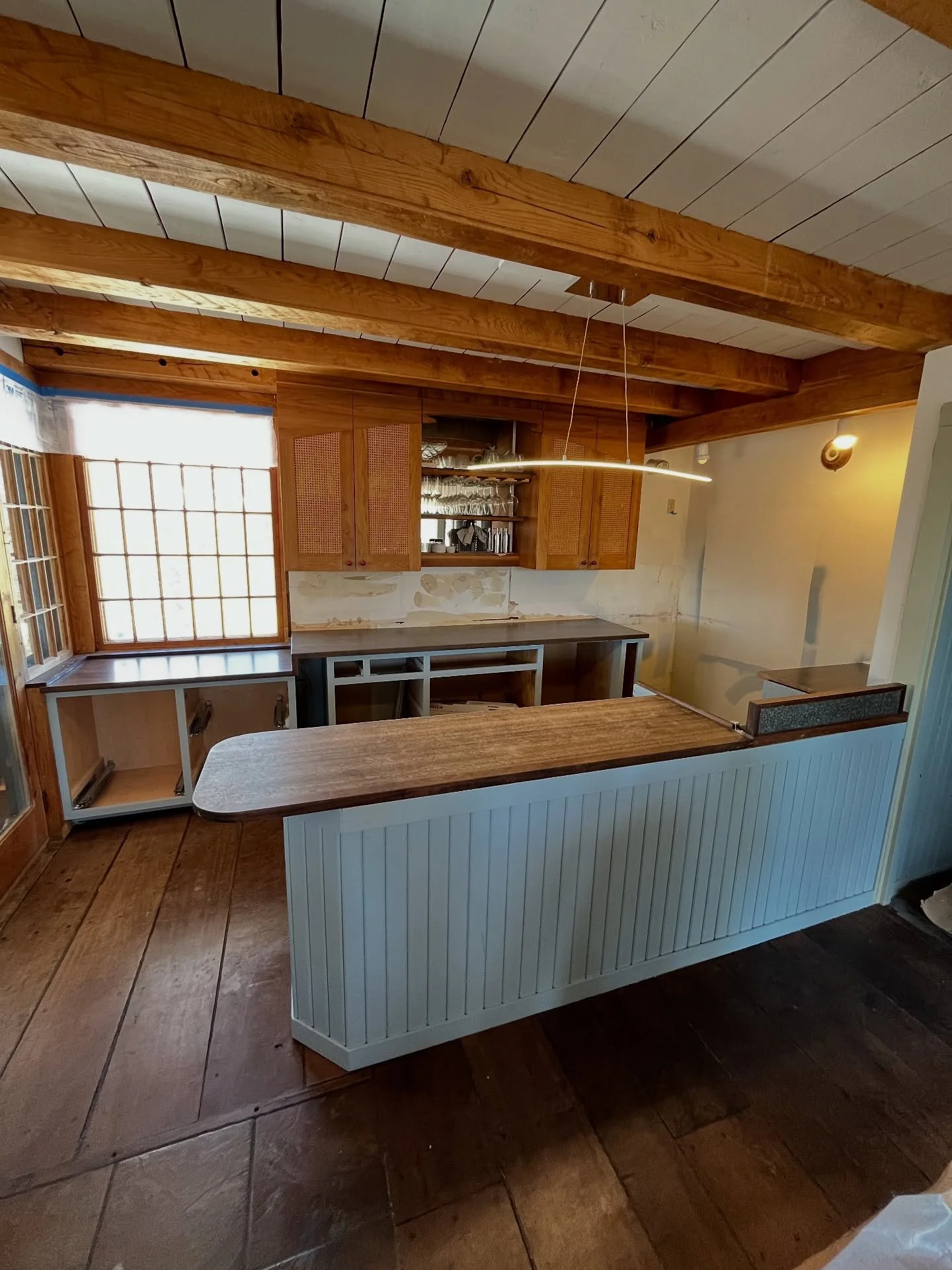 Freshly sprayed kitchen boxes in Buxton Blue, and bedroom cabinets primed with two coats of shellac.