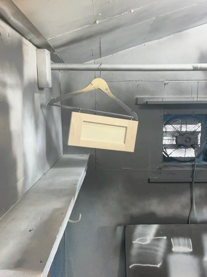 Spraying shellac on cabinet doors today.