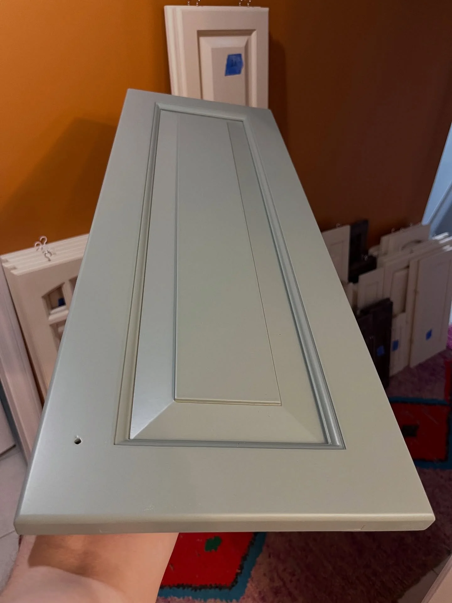 Deep grained, varnished oak that we transformed into a beautiful flawlessly finished cabinet door including multiple coats of primer and grain filling prior to spraying sleek top coats.