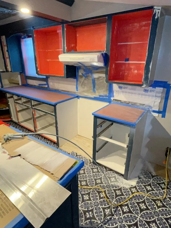 Lots going on here. Spraying two coats of primer. Spraying first top coat inside boxes. Sprayed primer on all drawers and foray top coat on drawer. The fake floor tiles will be torn up - why we didn&rsquo;t mask the floor. Same with the fake tin ceil