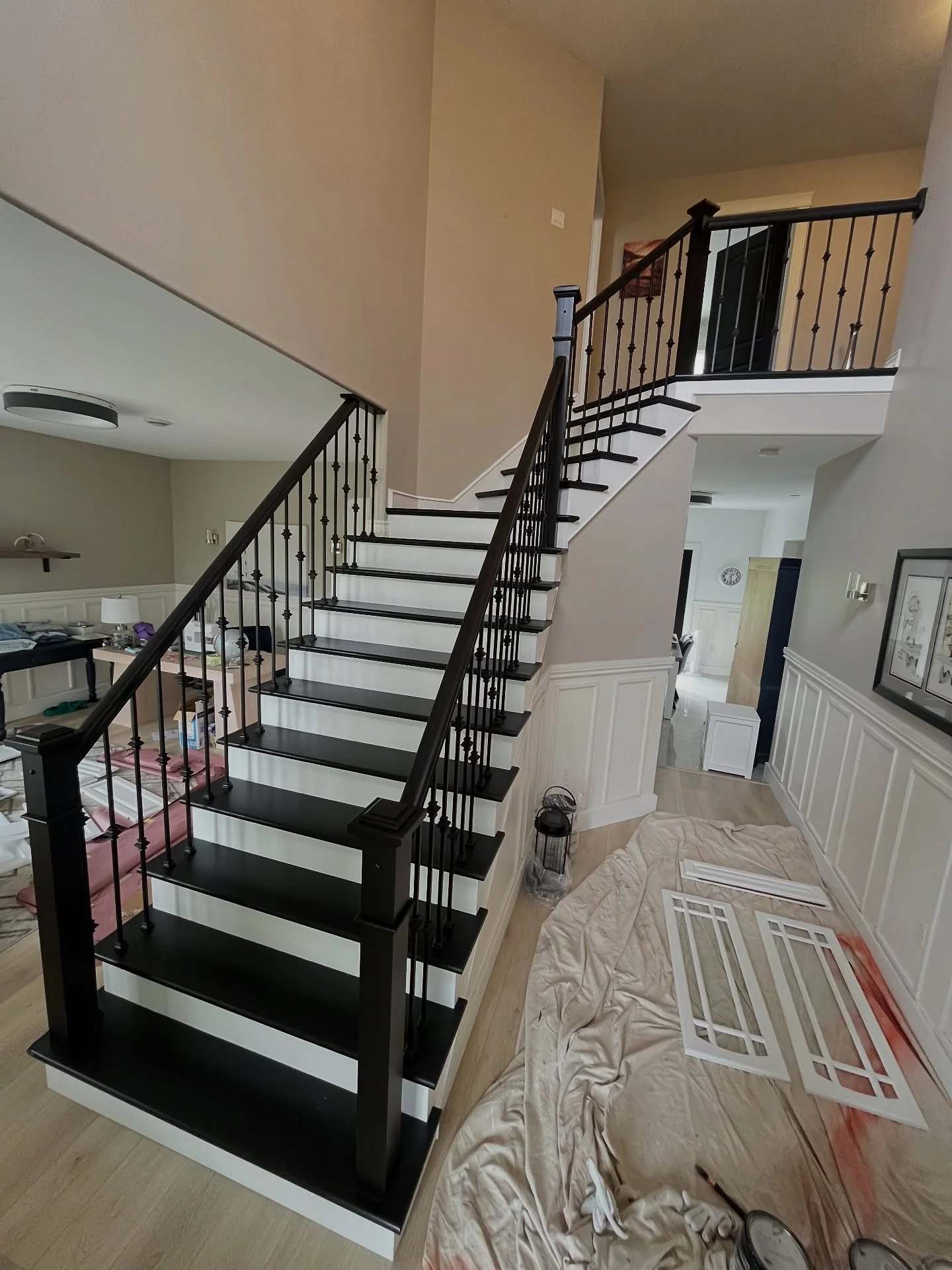 Man this was a journey. First we masked off the entire area with plastic curtain walls, taped off all floors, added ventilation, taped off the second level, then washed the staircase, sanded, de-dusted with vacuum and tack cloth, sprayed two coats of