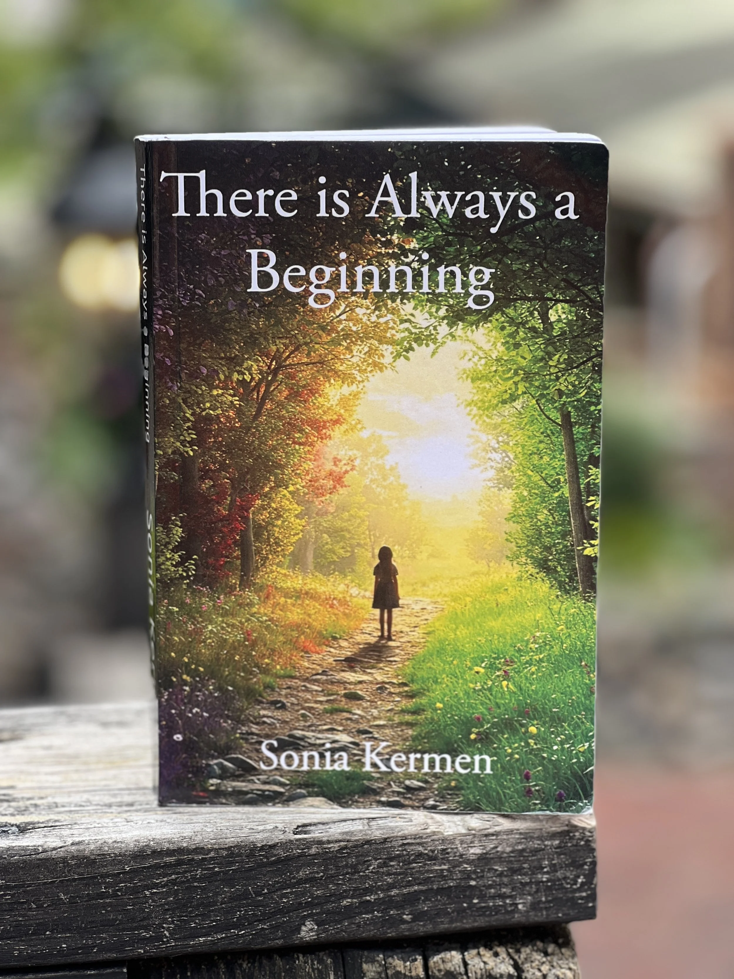 A book cover with a picture of a forest path at sunrise, showing trees with green and fall-colored leaves, and a girl walking down the path. Title says 'There is Always a Beginning' and author is Sonia Kermen.