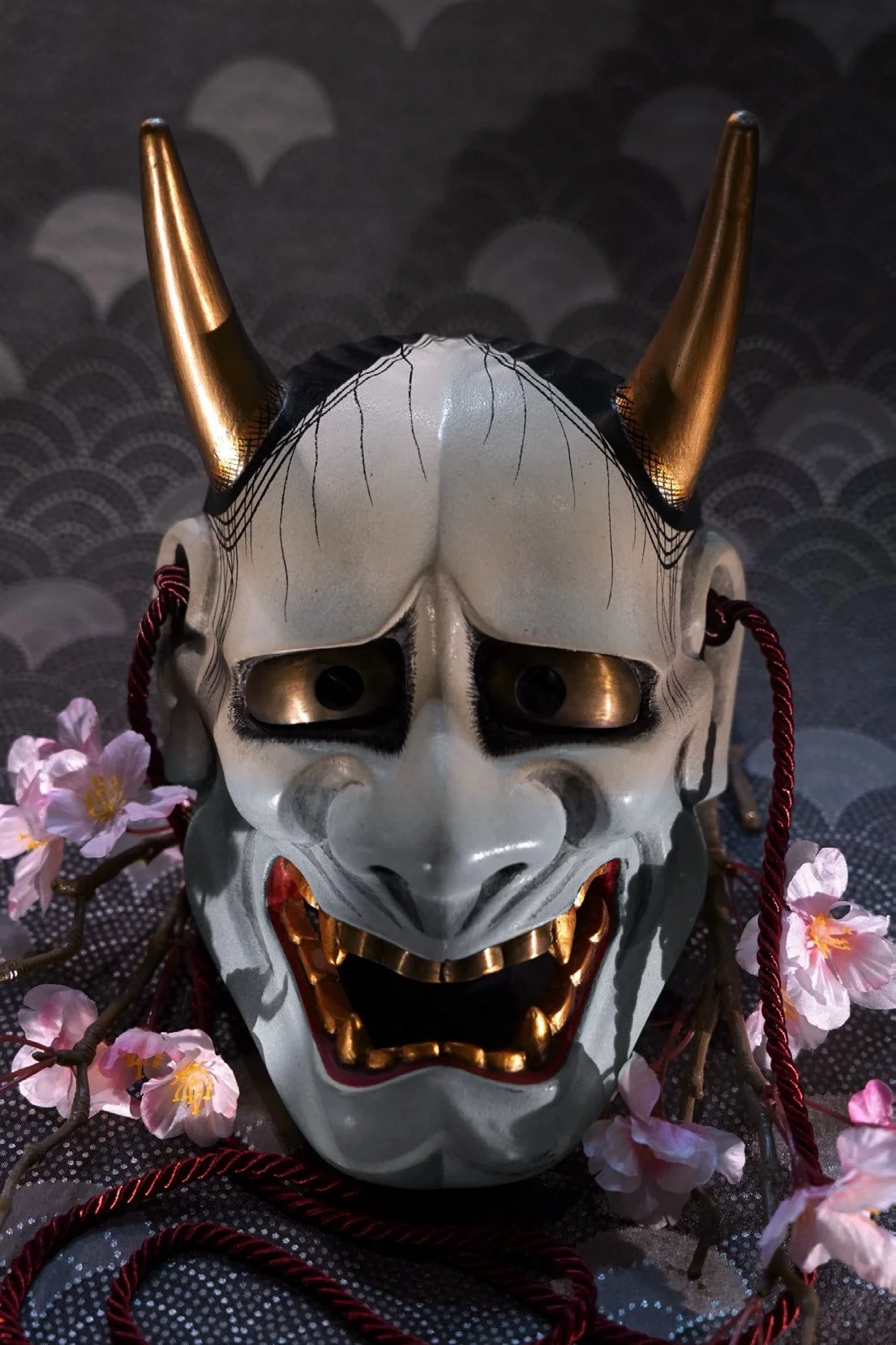 Traditional white Hannya Noh mask reference art with golden horns and sharp teeth, featured in 184-page Japanese tattoo and sculpture guide
