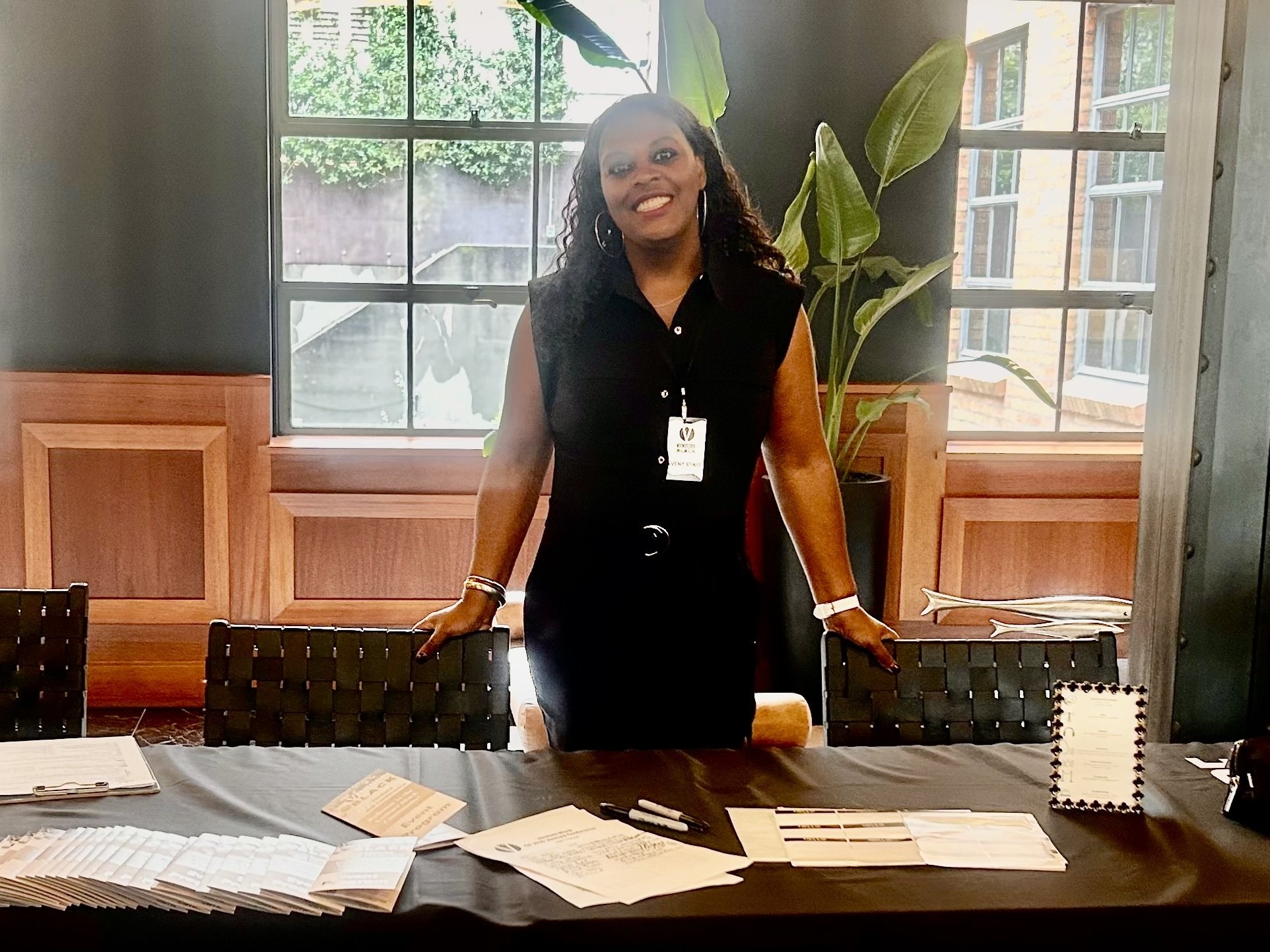 Monique Shields, Founder of Executive Allure hosting client registration table