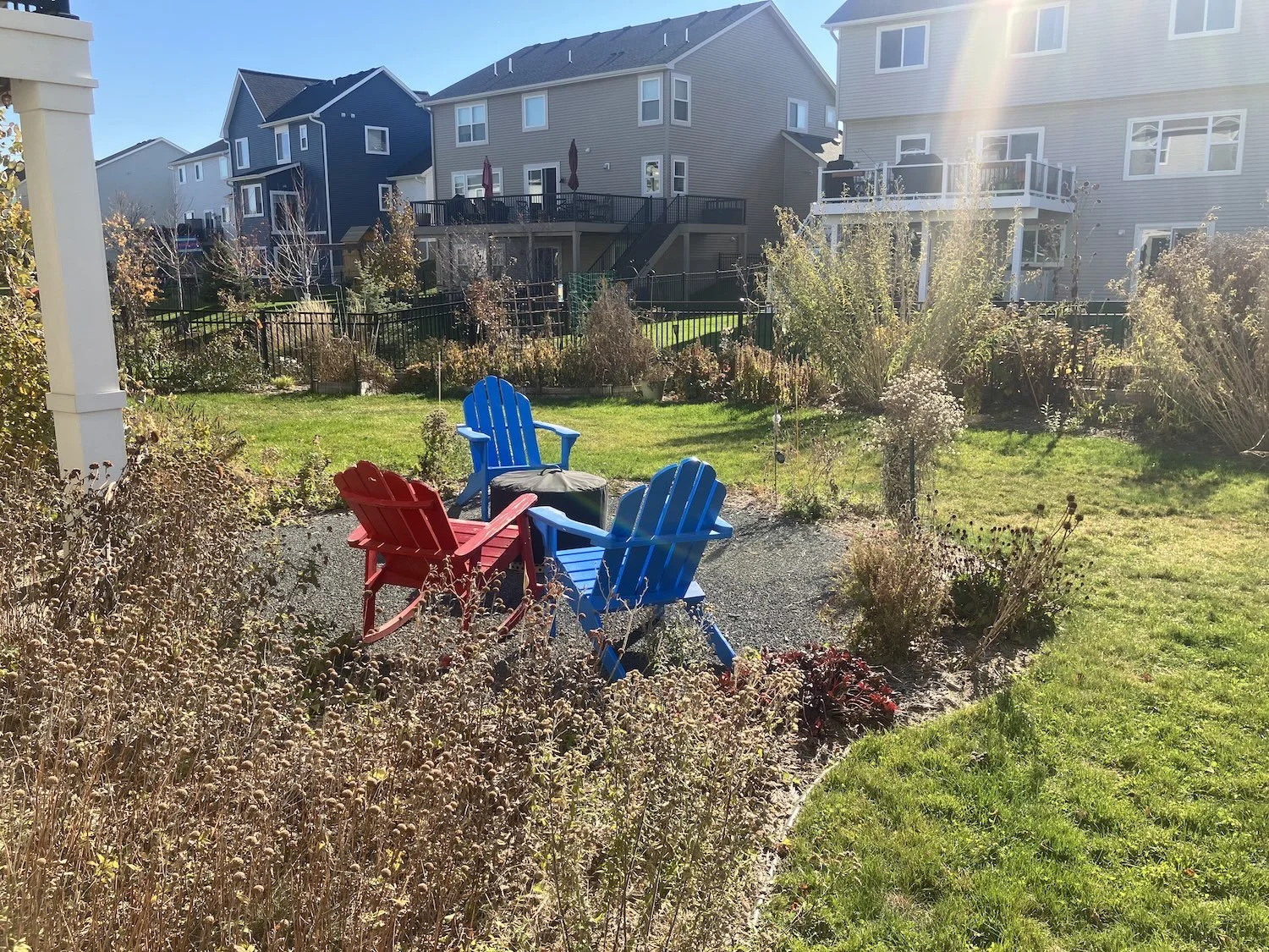 family enjoying a patio surrounded by native and edible plants designed for low maintenance