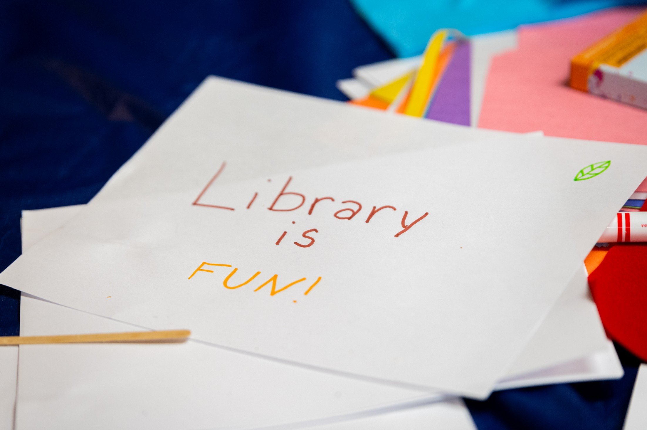  A piece of paper with the handwritten words, “Library is FUN!” 