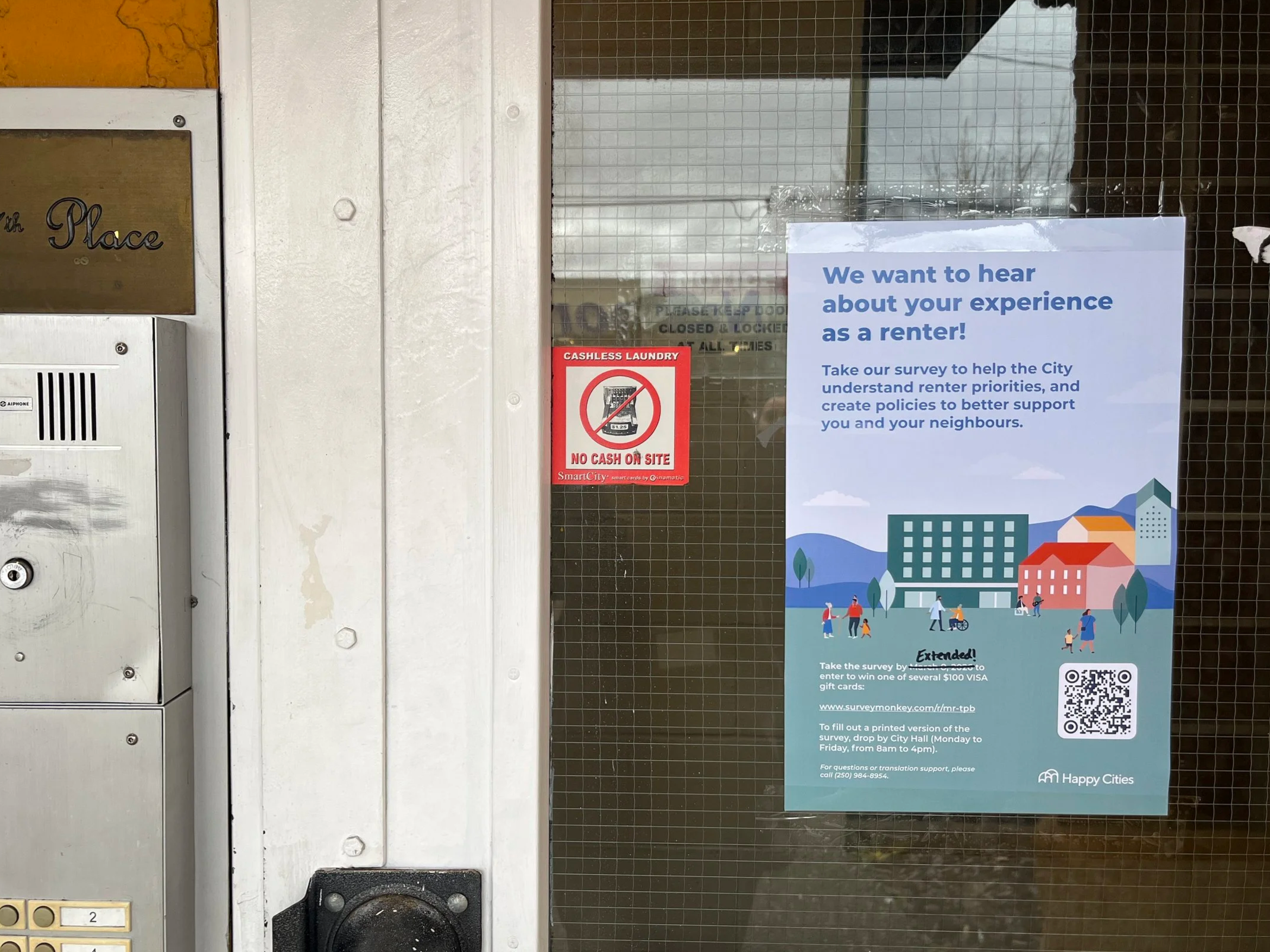 Happy Cities poster taped to a door of one of the rental buildings: “We want to hear about your experience as a renter! Take our survey to help the City understand renter priorities, and create policies to better support you and your neighbours.”