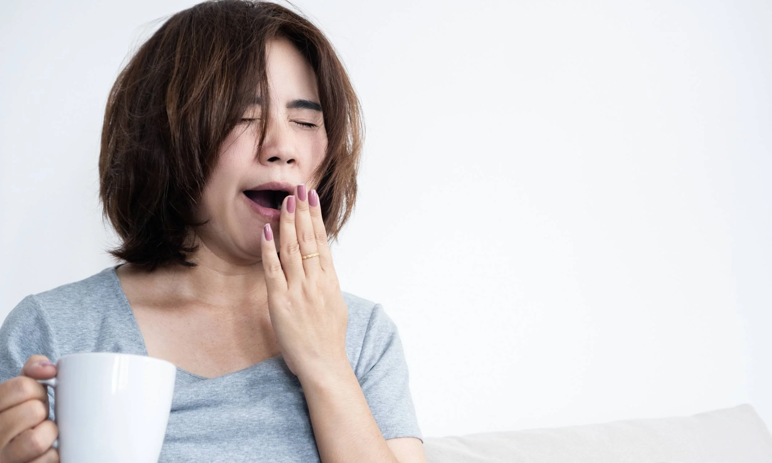 Person yawning from daytime tiredness, a common sign of possible sleep apnoea, assessed and supported at Sleep Matters Clinic Wellington