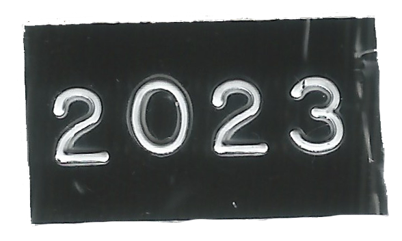 Embossed tape reading “2023”.