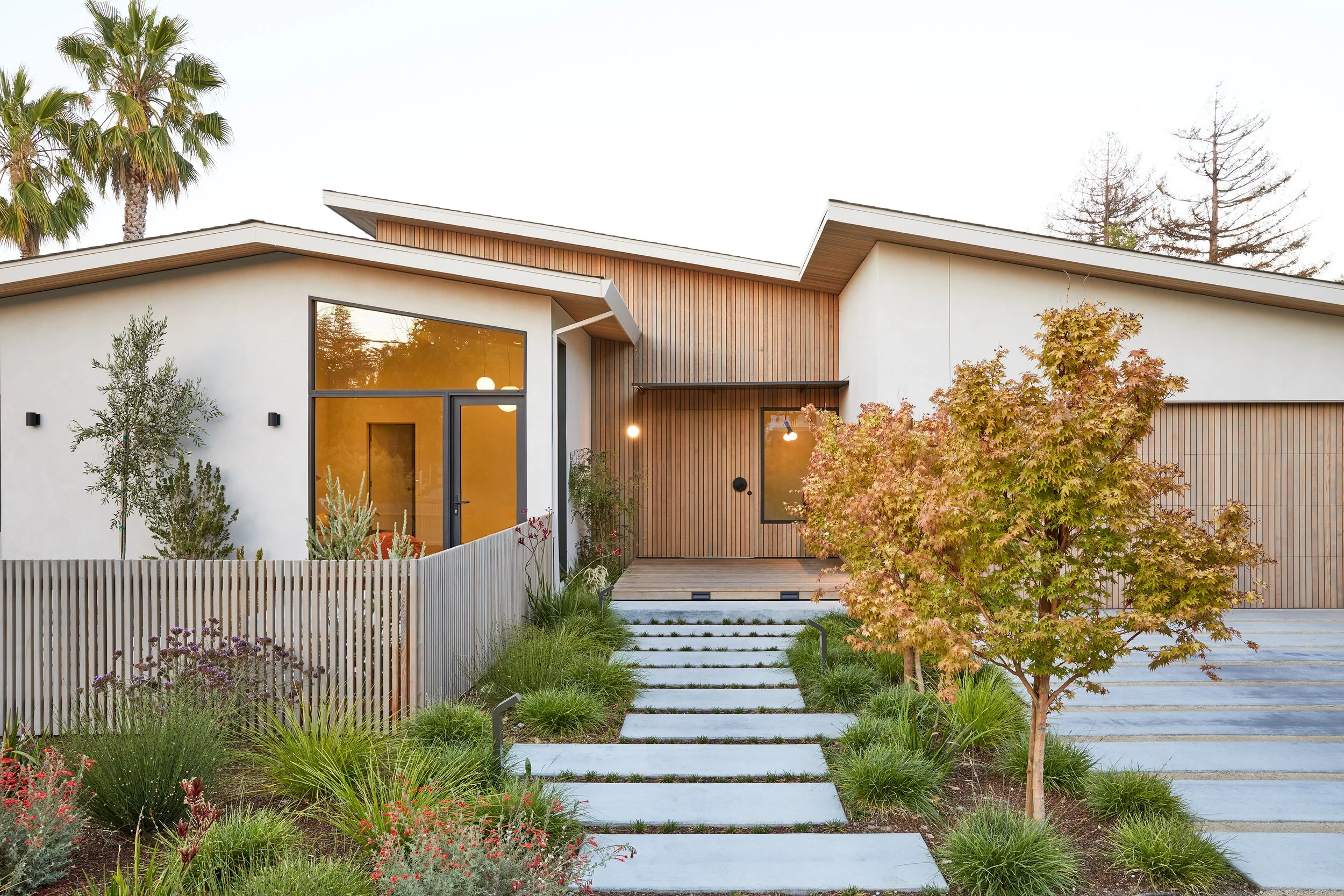 The front entry, featuring vertical wood cedar siding that wraps seamlessly from the outside in. 