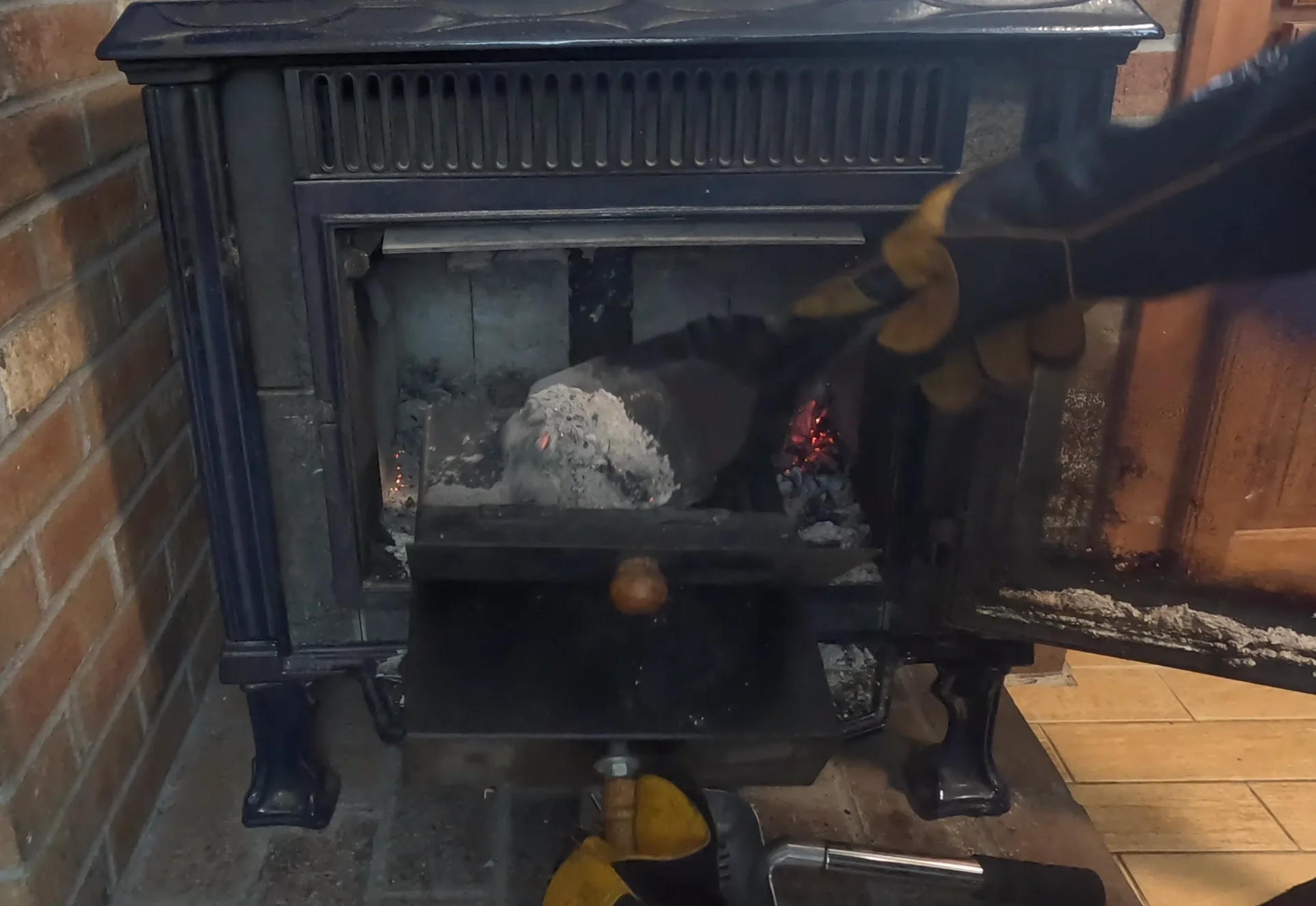 dump ashes into the ash scoop with a shovel