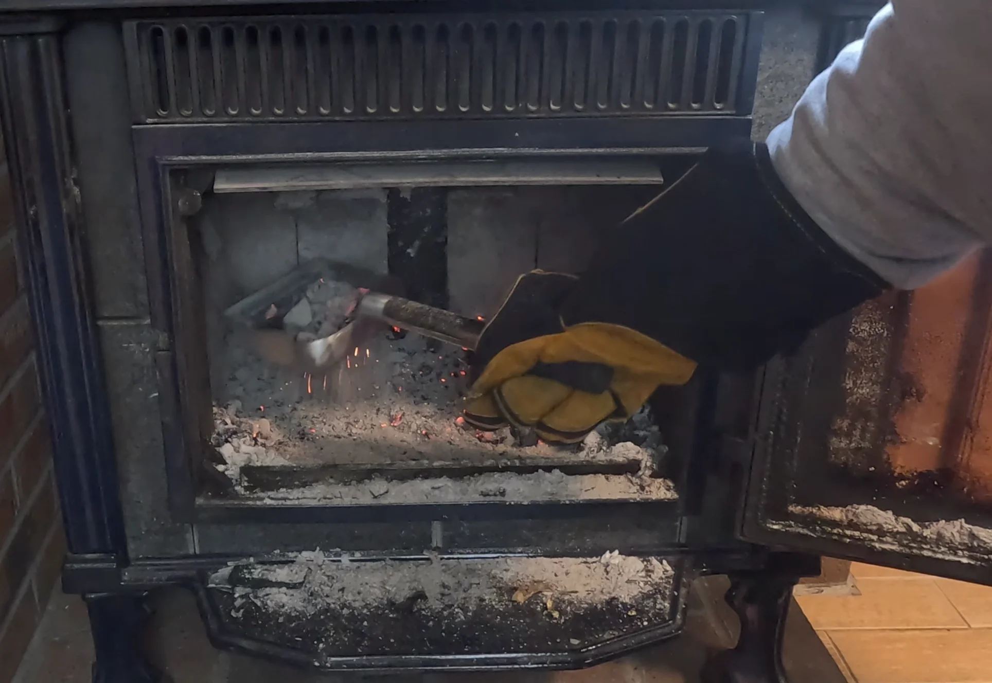 sifting ashes from a wood stove with the ash scoop sifter