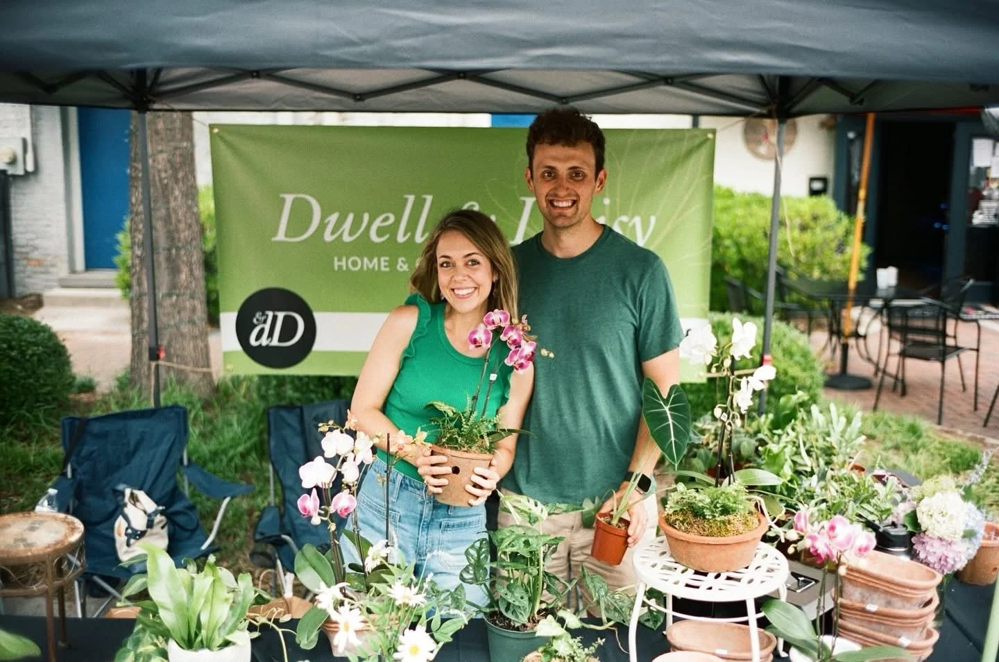 A friend took this photo on film on May 25, 2024. We celebrated two whole years of Dwell and Daisy this week!

Two years ago, we took a gamble on purchasing pots, picked out some orchids and plants we loved most, and set up for our very first market.