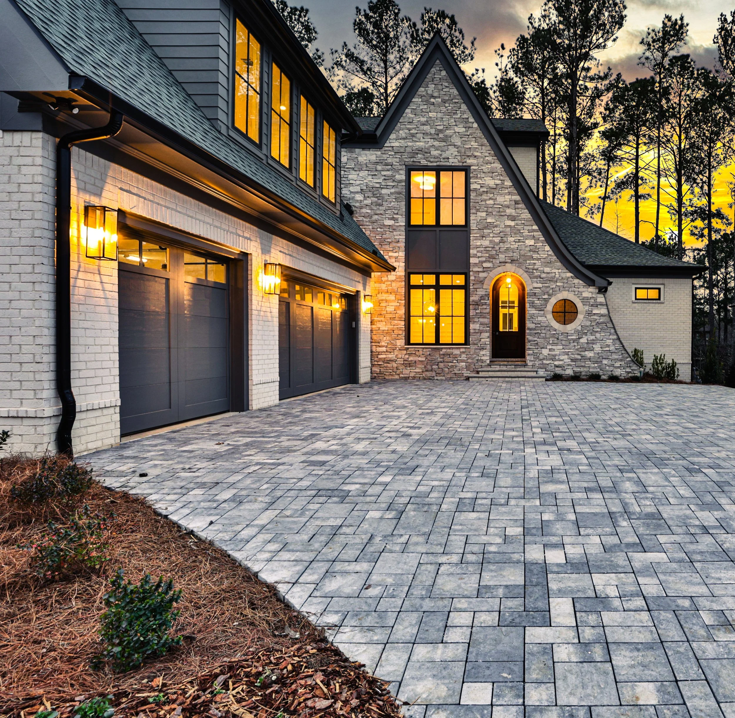 luxury custom home in acworth ga by ADG custom homes with stone paver driveway and stone arch entrance modern tudor style.jpg