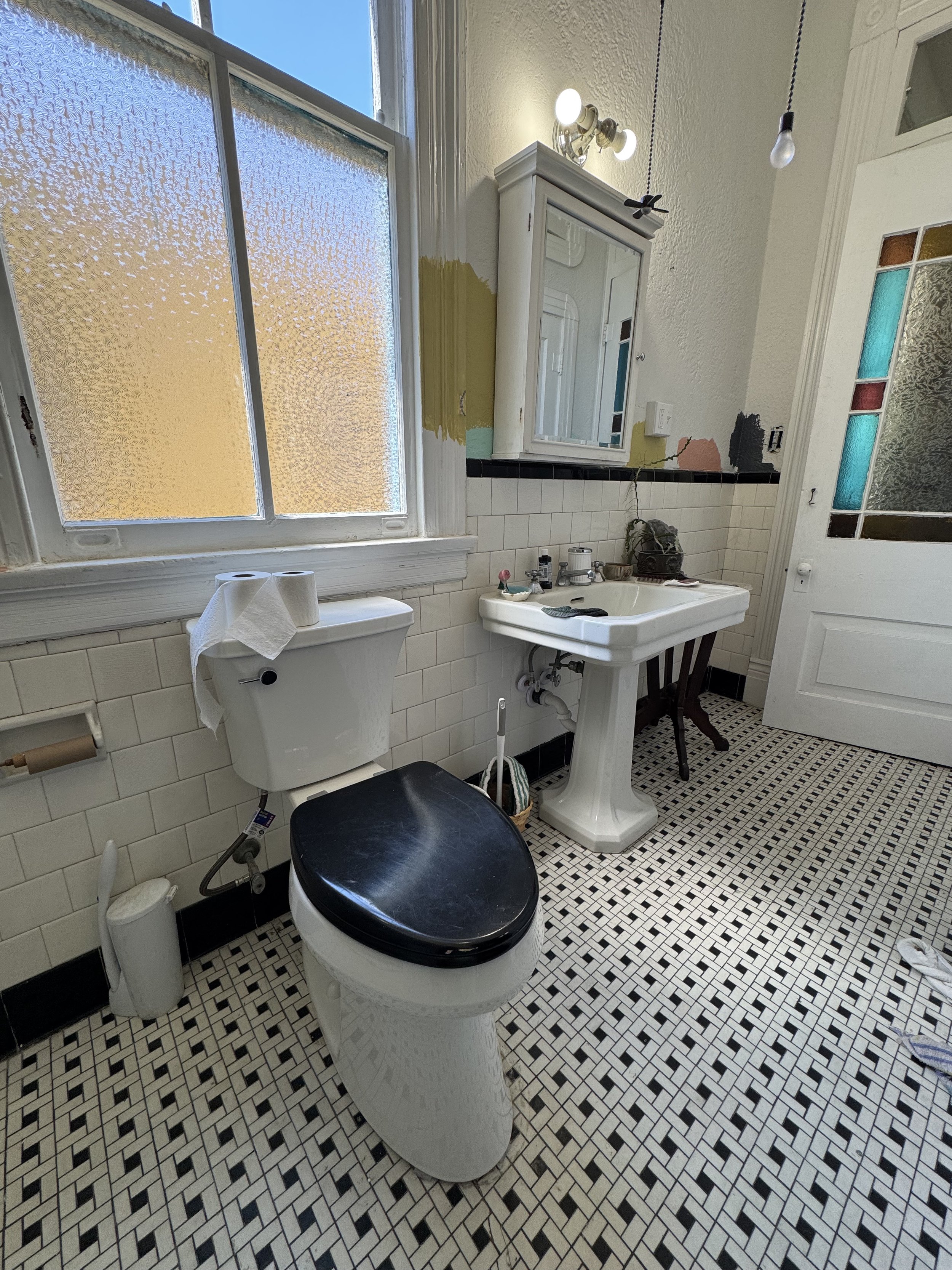Modern tiled shower remodel with glass enclosure and patterned tile feature wall in New Orleans bathroom renovation