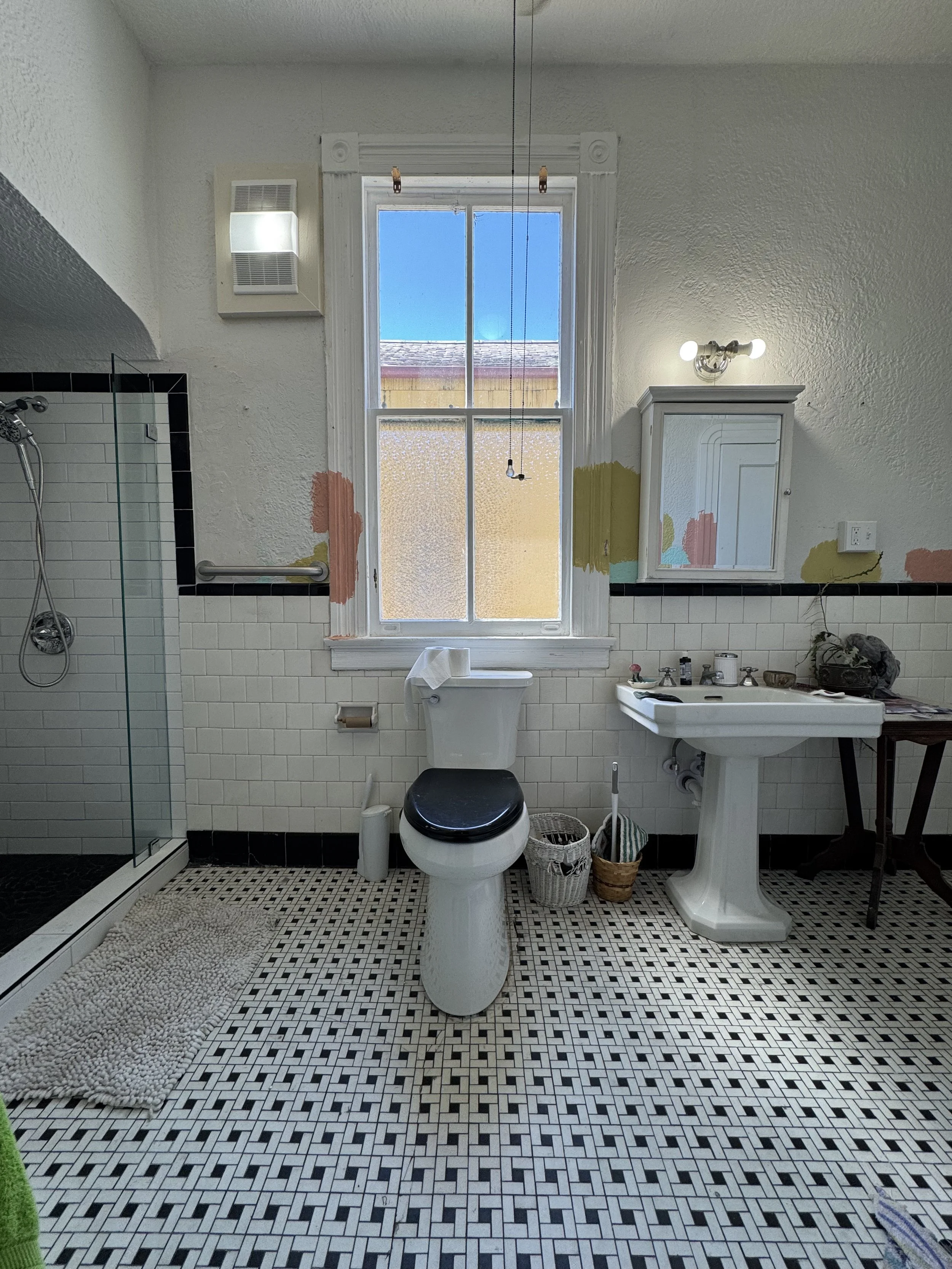 Modern tiled shower remodel with glass enclosure and patterned tile feature wall in New Orleans bathroom renovation