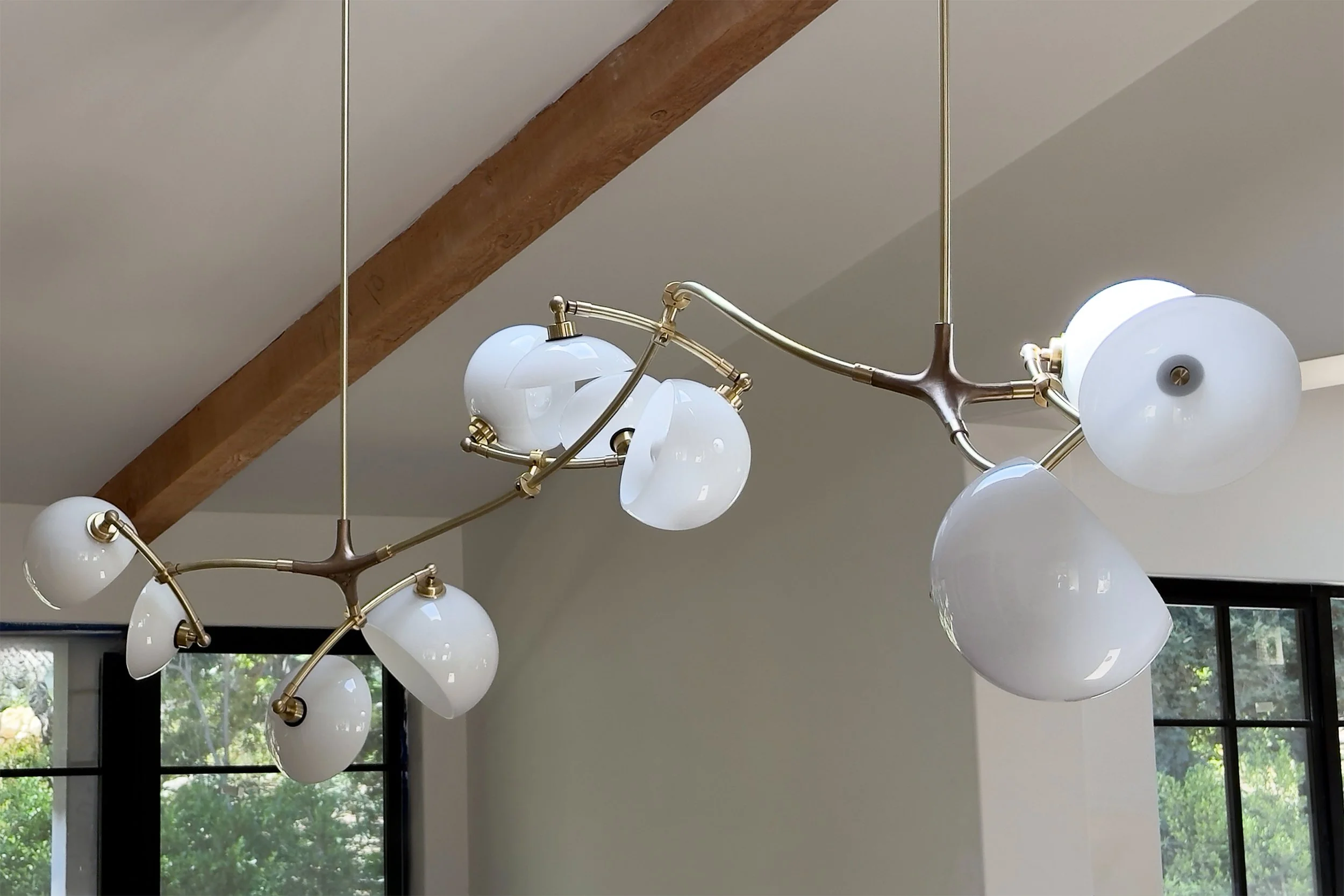 Blossom Chandelier by Neptune Glassworks—glass elements bloom like petals on brass arms. Handcrafted in Los Angeles.