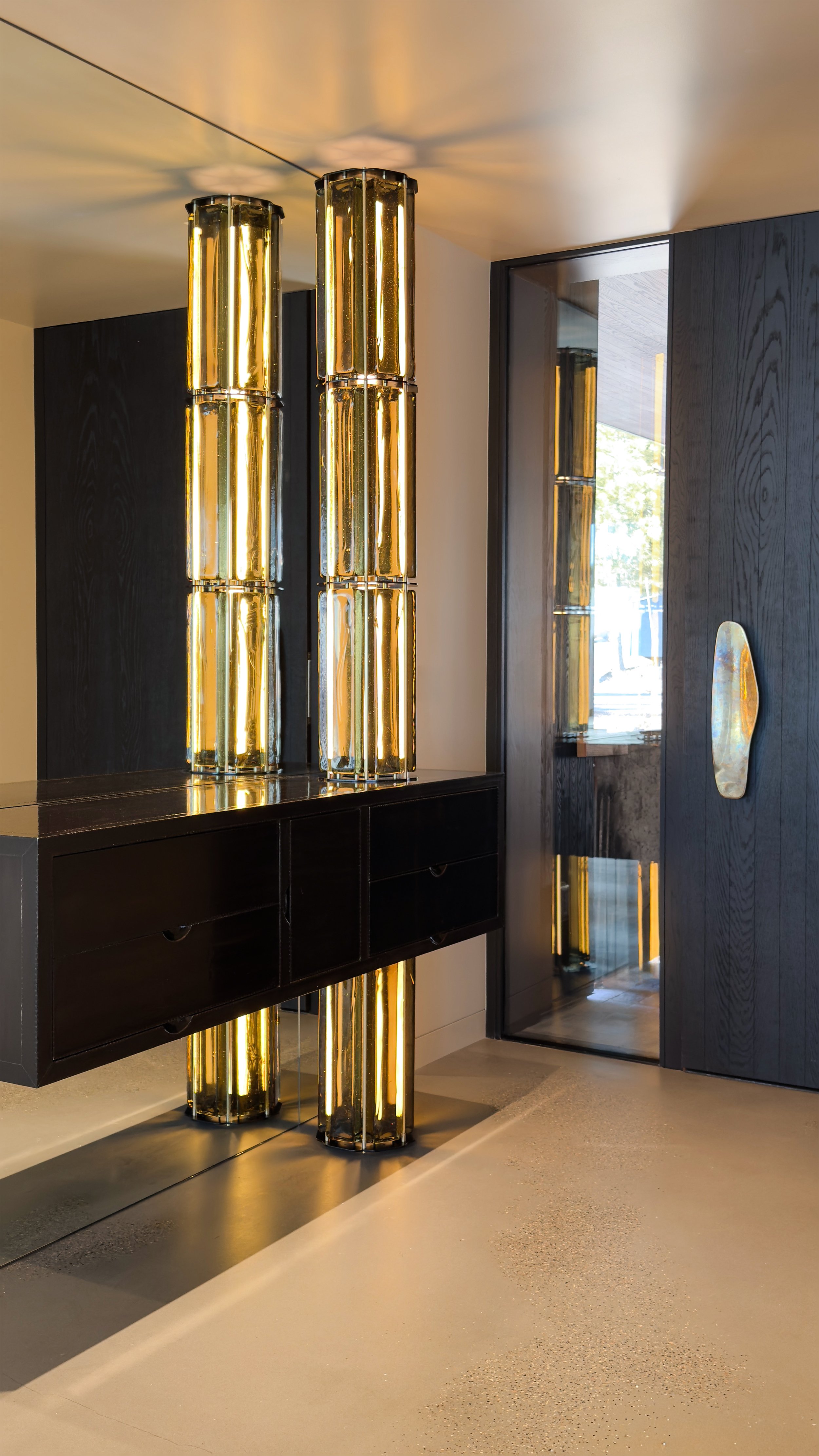 Custom Tower Lamp by Neptune Glassworks for a private residence in Lake Tahoe.  Cast glass blocks suspended from a custom armature that intersects a floating credenza.