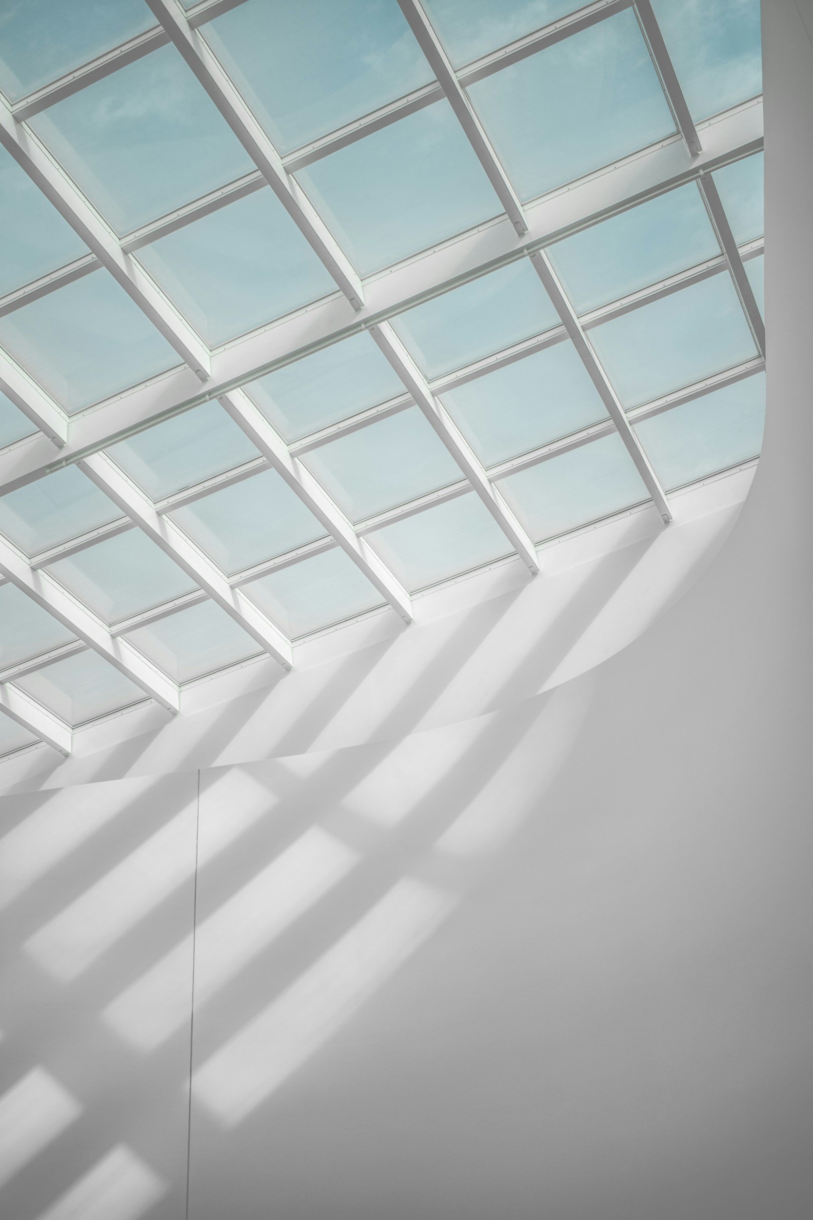 Sunlight filtering through a geometric skylight, illustrating the structured support our Melbourne psychologists provide for adults experiencing ADHD burnout.