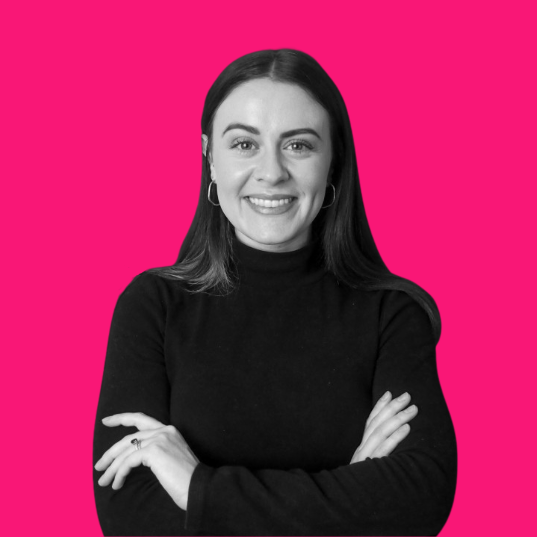 Adjuvant Event Services freelancer, Genevieve Page, smiling, and wearing a black turtleneck crossing her arms.