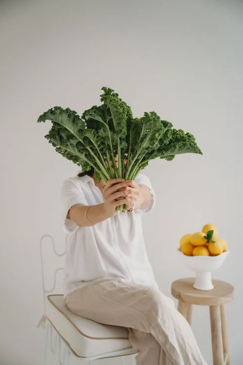 Jade holding a bunch of kale