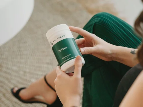 Jade holding a practitioner supplement tub
