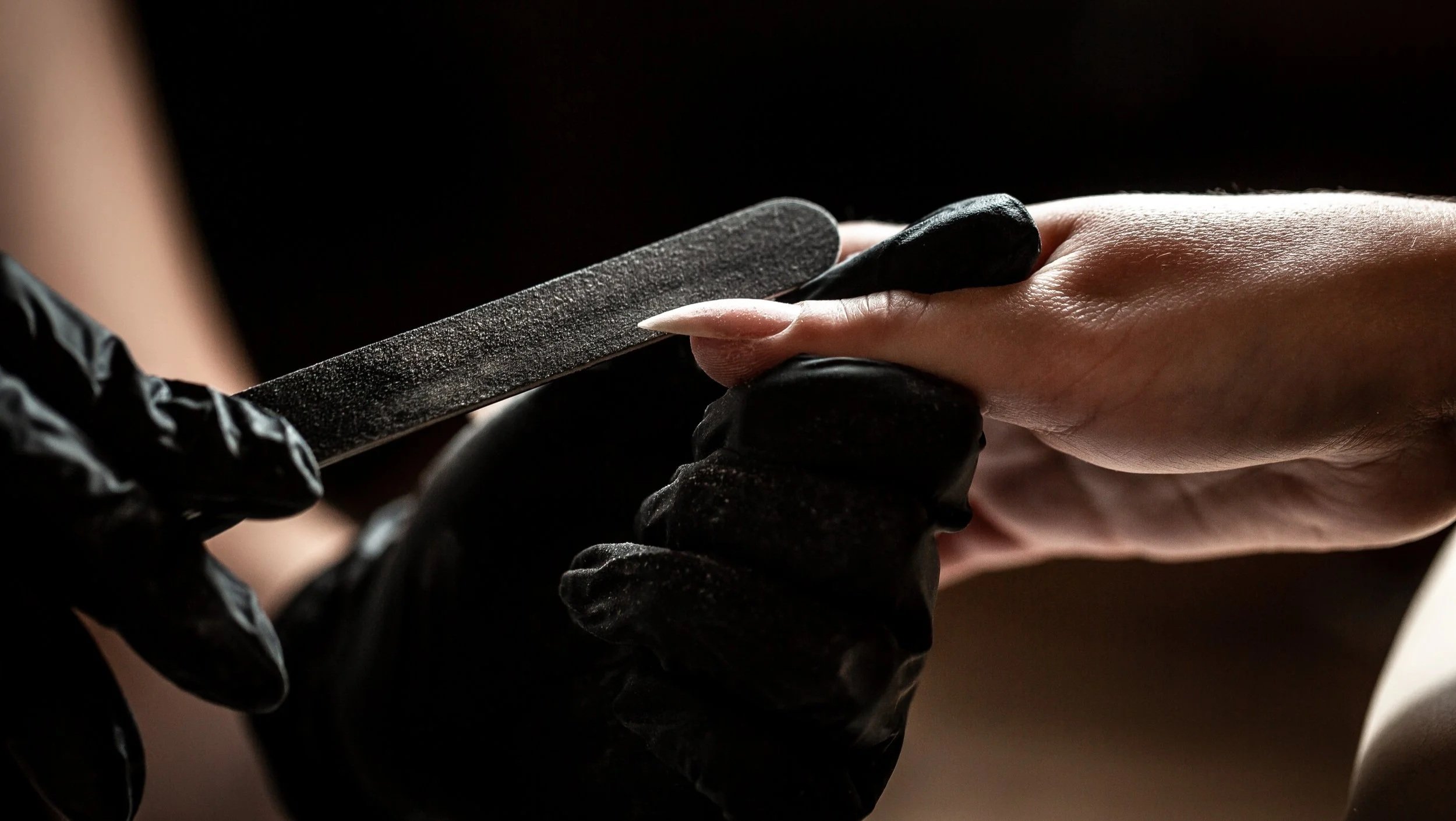 Close-up of a nail technician fixing a nail at HER Beauty clinic in Copenhagen Frederiksberg.