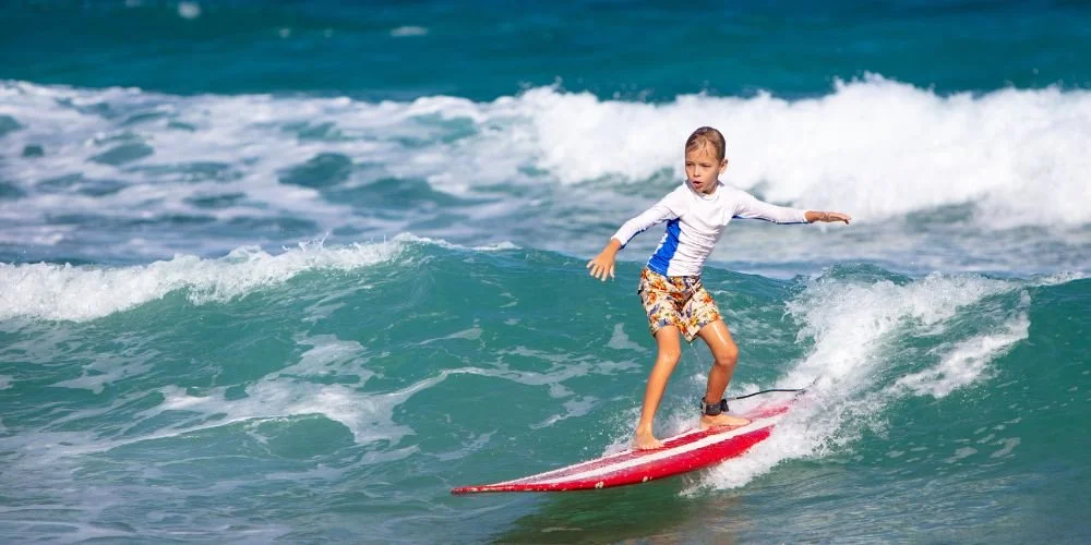 Child surfing in the school term surf program