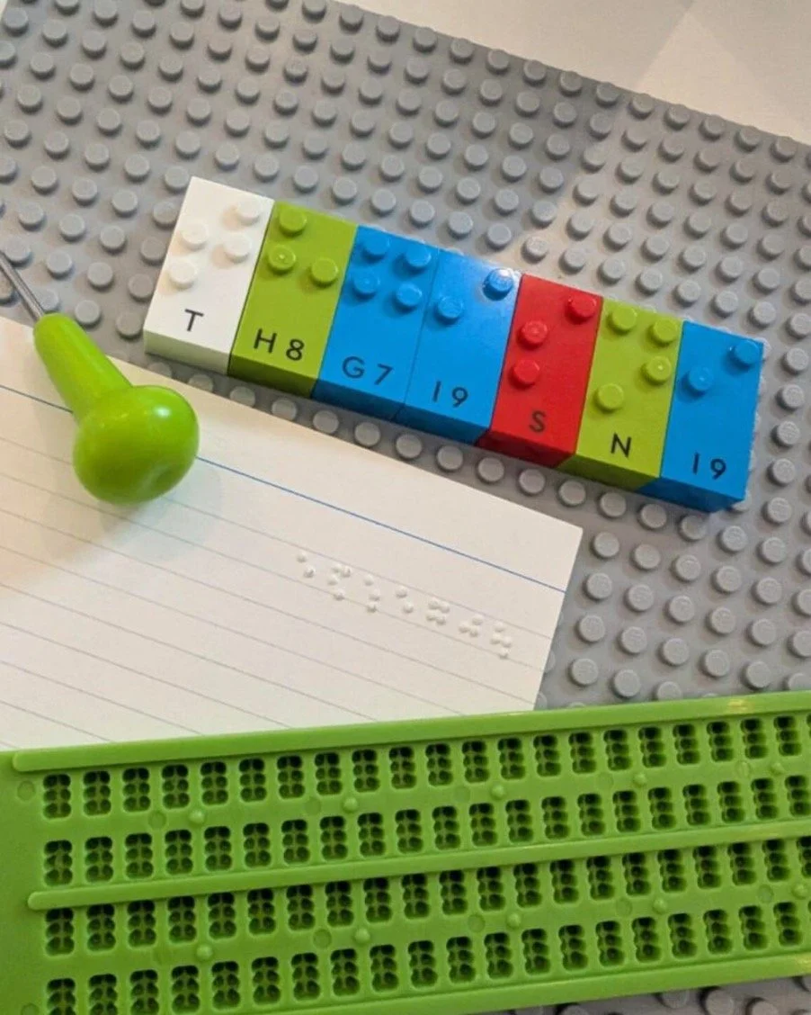 A braille slate for producing braille by hand and a set of Lego braille bricks