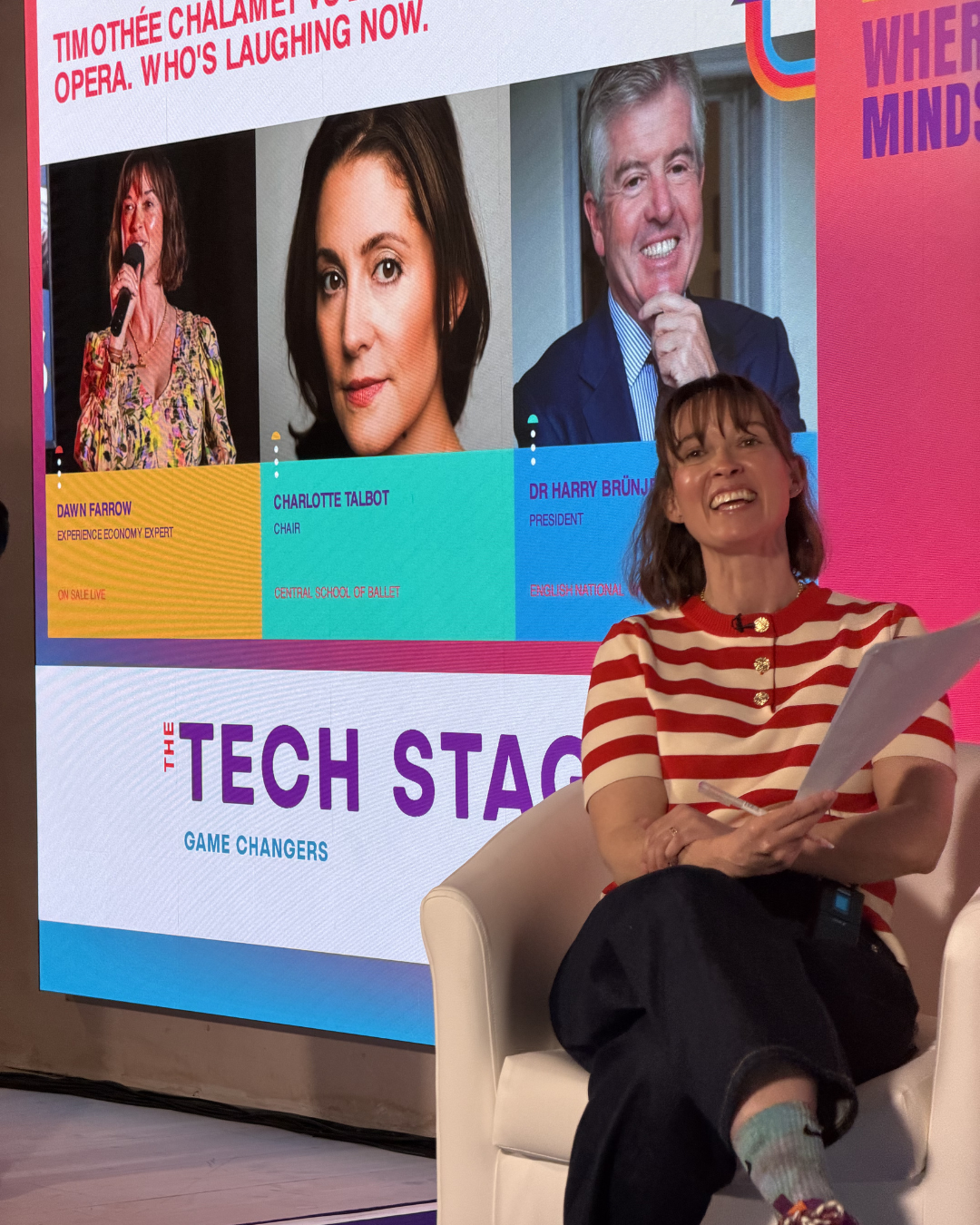 Dawn Farrow laughs on stage presenting at Advertising week europe hosting a panel in response to Timothee Chalamet's comments with ENO and Central School of Ballet