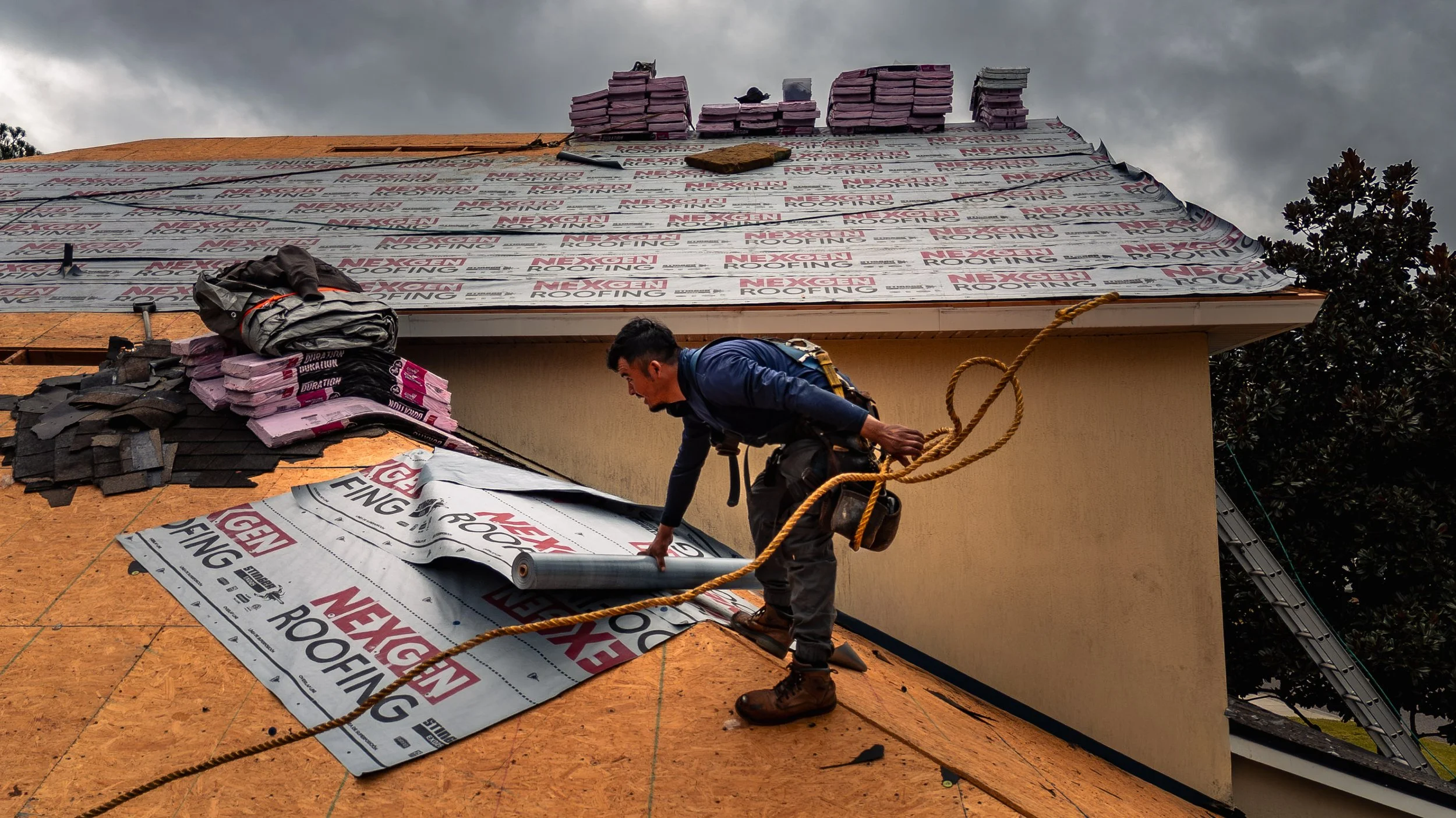 Professional roof installation in Jacksonville FL - NexGen Roofing contractor installing new residential roof with proper safety equipment.