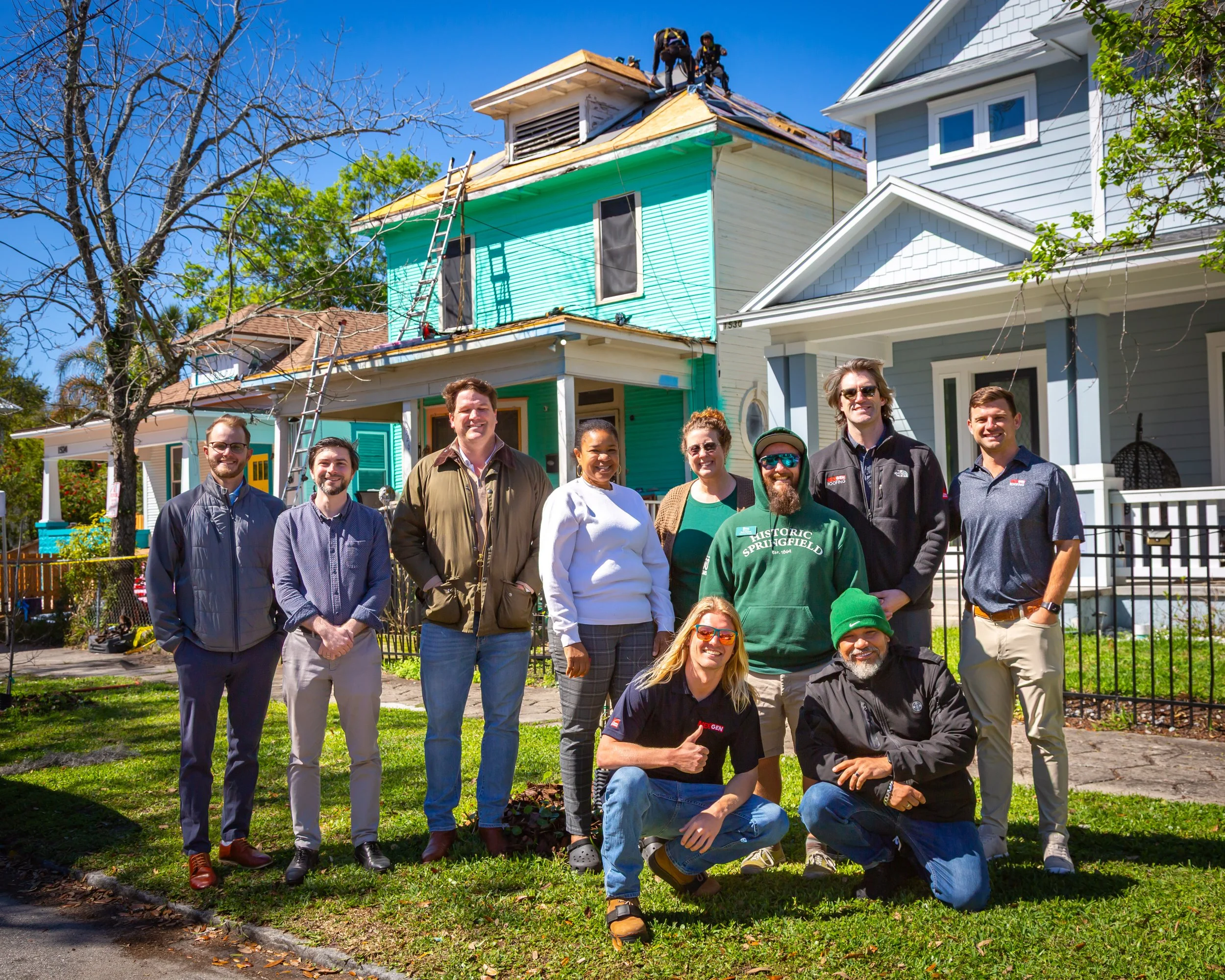NEXGEN Roofing team in front of a roof being replaced.